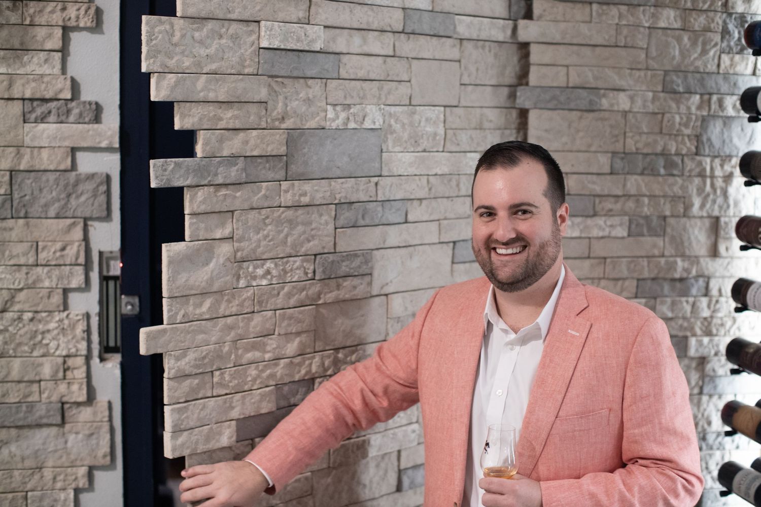 Modern bar interior with stone brick walls and decorative lighting.