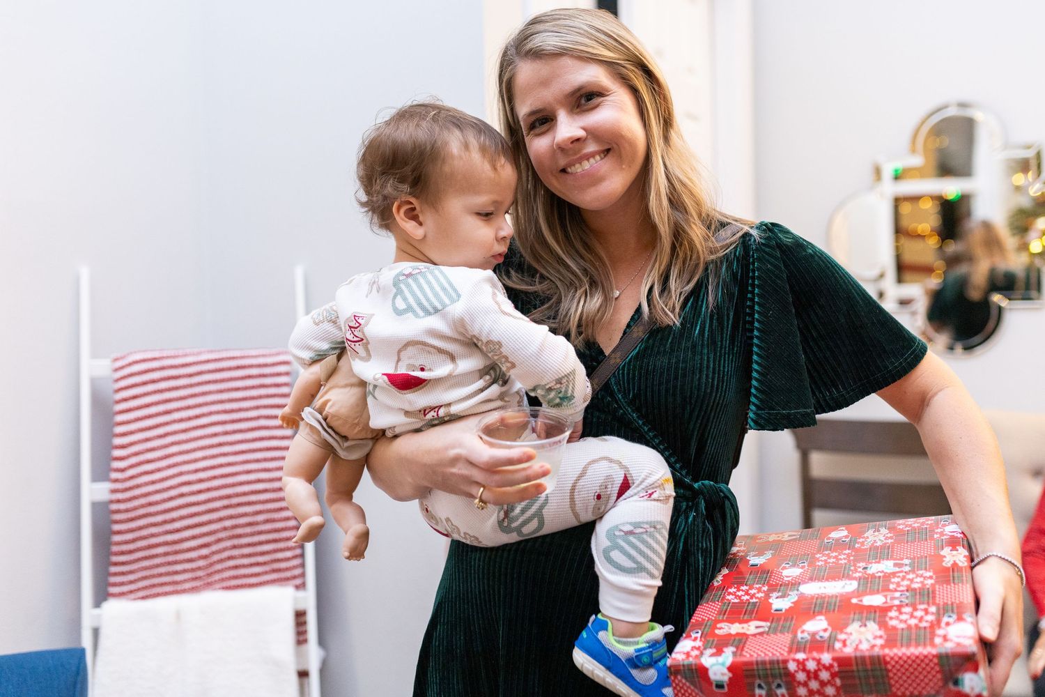 A tender moment captured during a Christmas celebration with holiday decorations in the background.