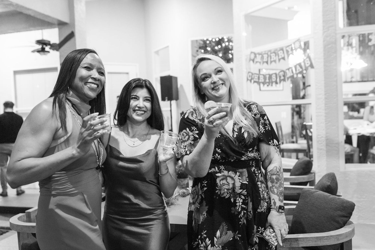 Group of women dancing and celebrating in a bright indoor space.