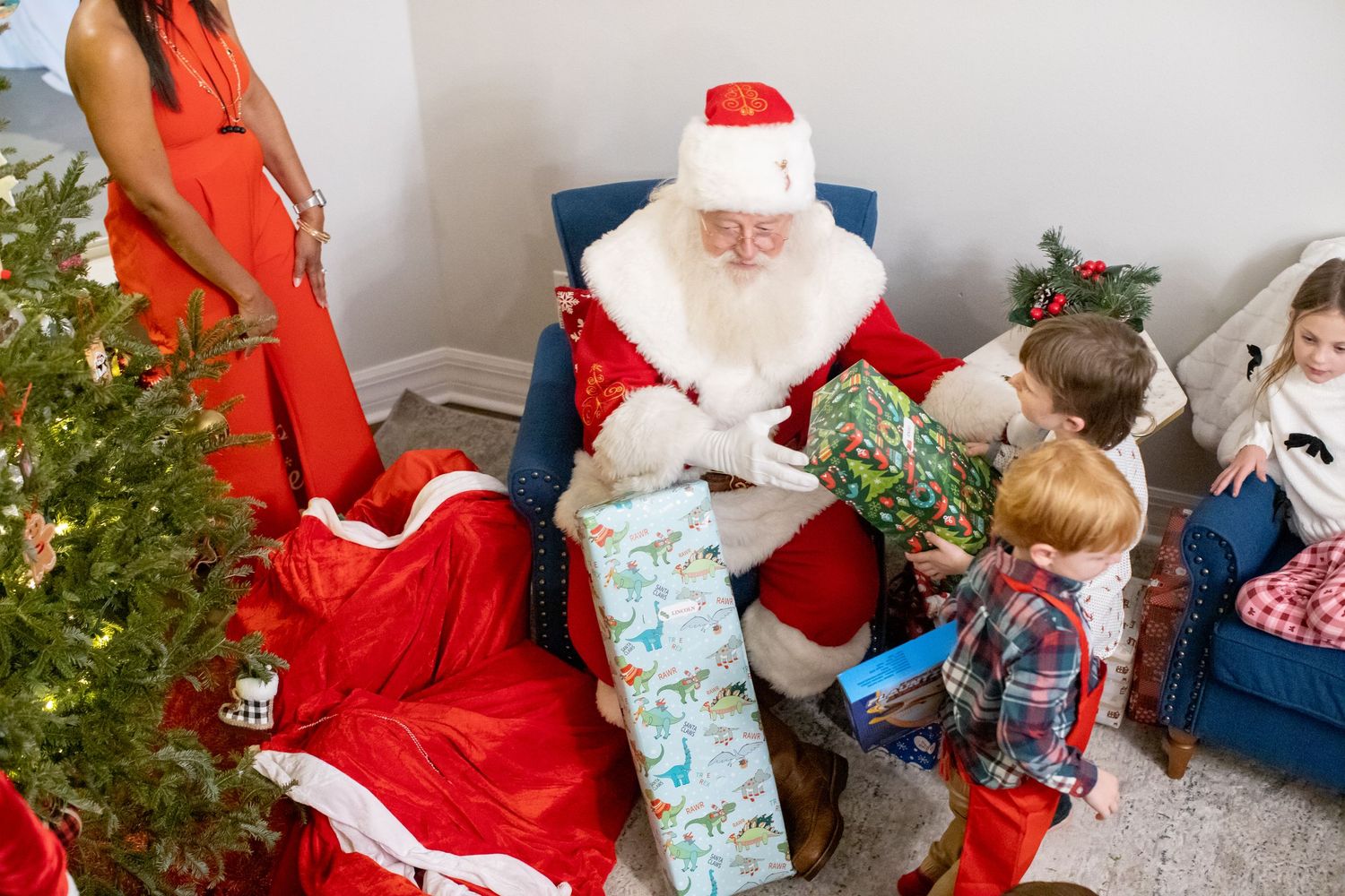 A festive holiday scene with a decorated Christmas tree and people celebrating together.