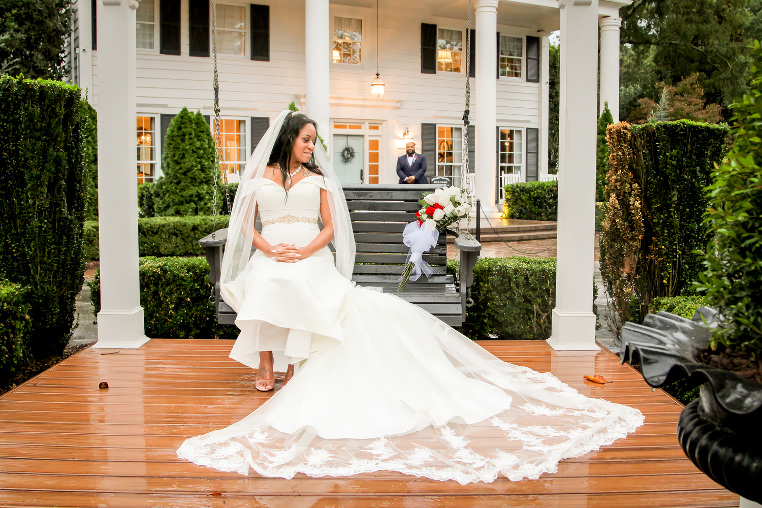 Elegant outdoor wedding venue with white columns and brick walkway in natural daylight.