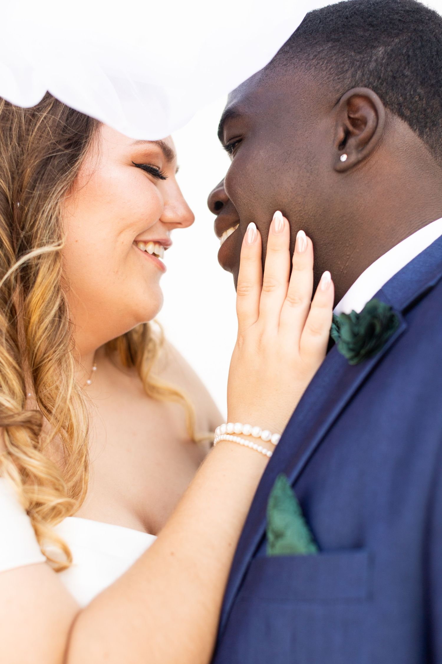 An intimate close-up moment between newlyweds sharing a tender moment.