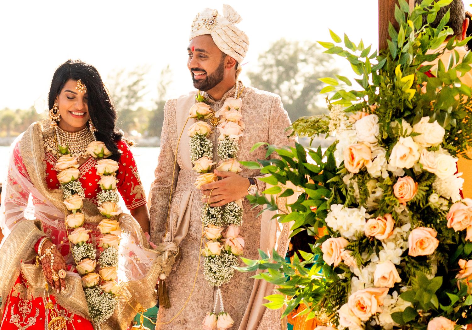 Wedding ceremony setup with elegant floral arrangements and traditional Indian decor.
