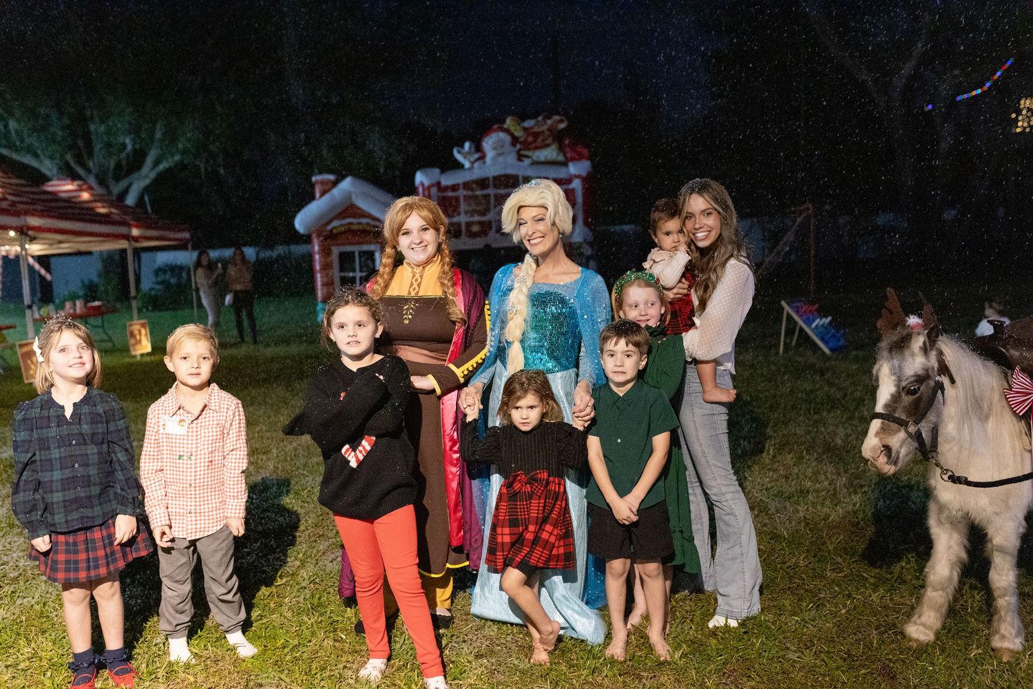 Group of children gathered outdoors at night for a holiday celebration.