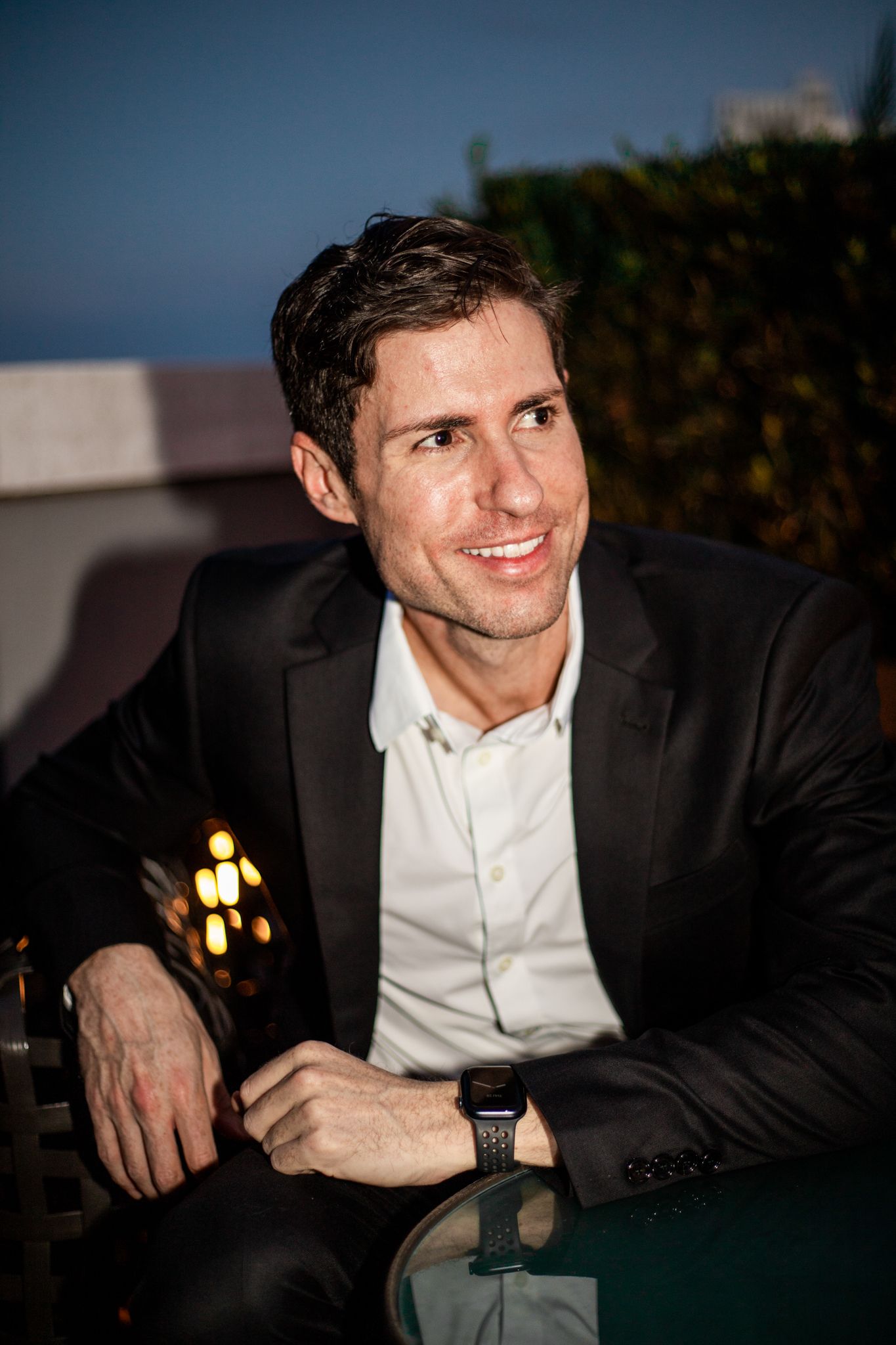 Evening portrait of person in formal attire at outdoor venue.