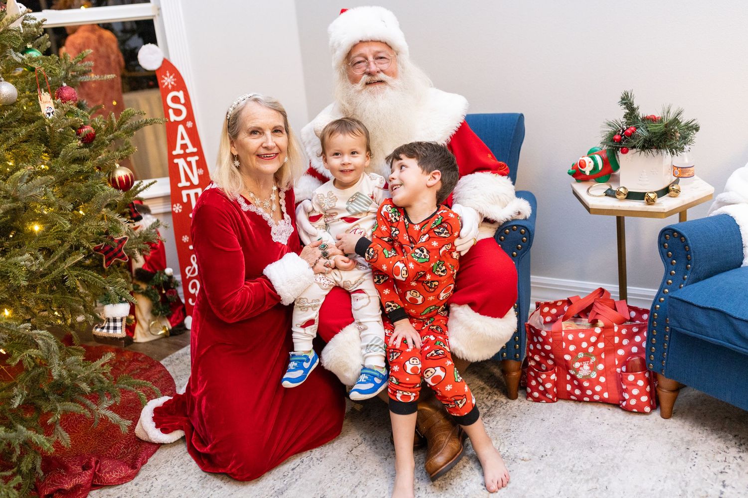 Christmas photo session with decorative holiday elements and blue furniture.