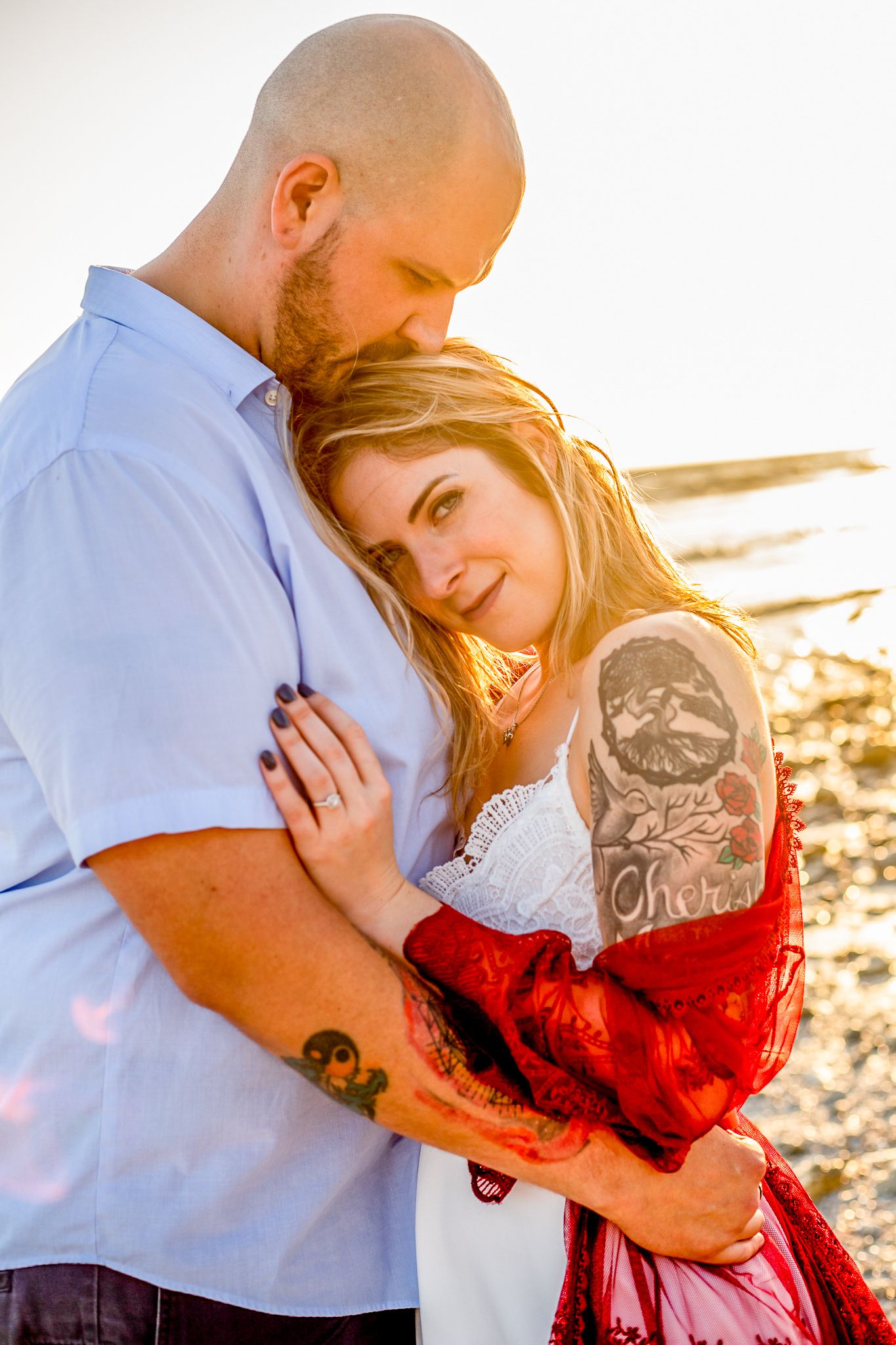 Intimate moments shared during coastal sunset photoshoot.