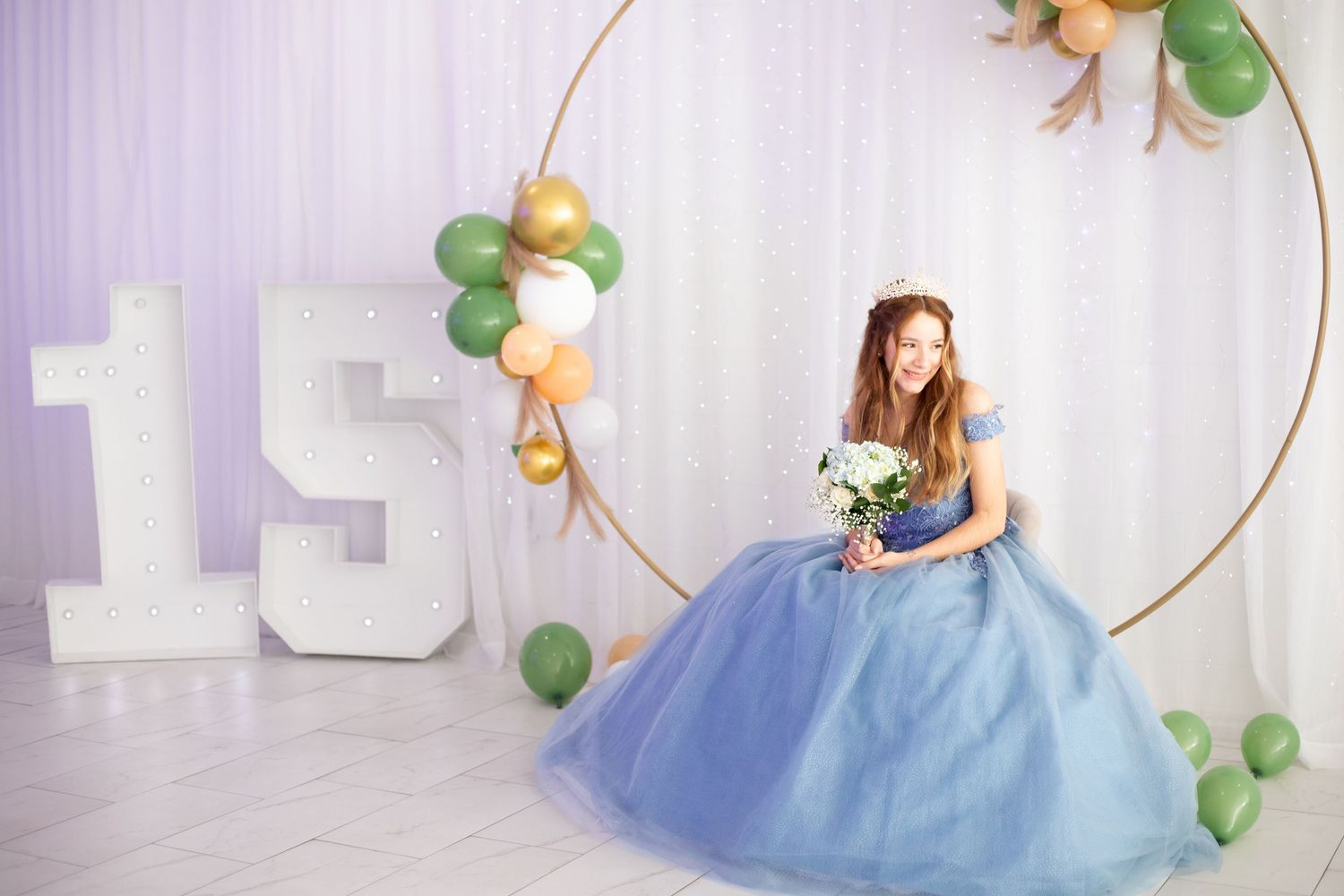 A flowing blue ballgown dress with tulle skirt and embellished bodice in an elegant party setting.