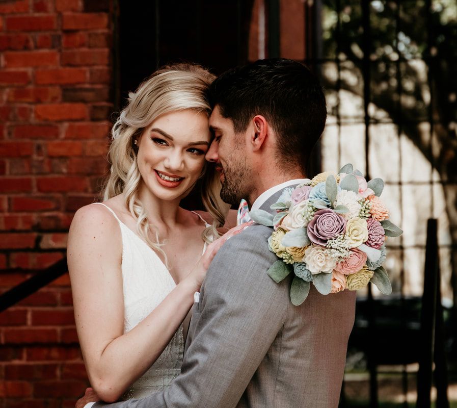 A romantic wedding photo series against a rustic brick wall backdrop with soft floral bouquet details.