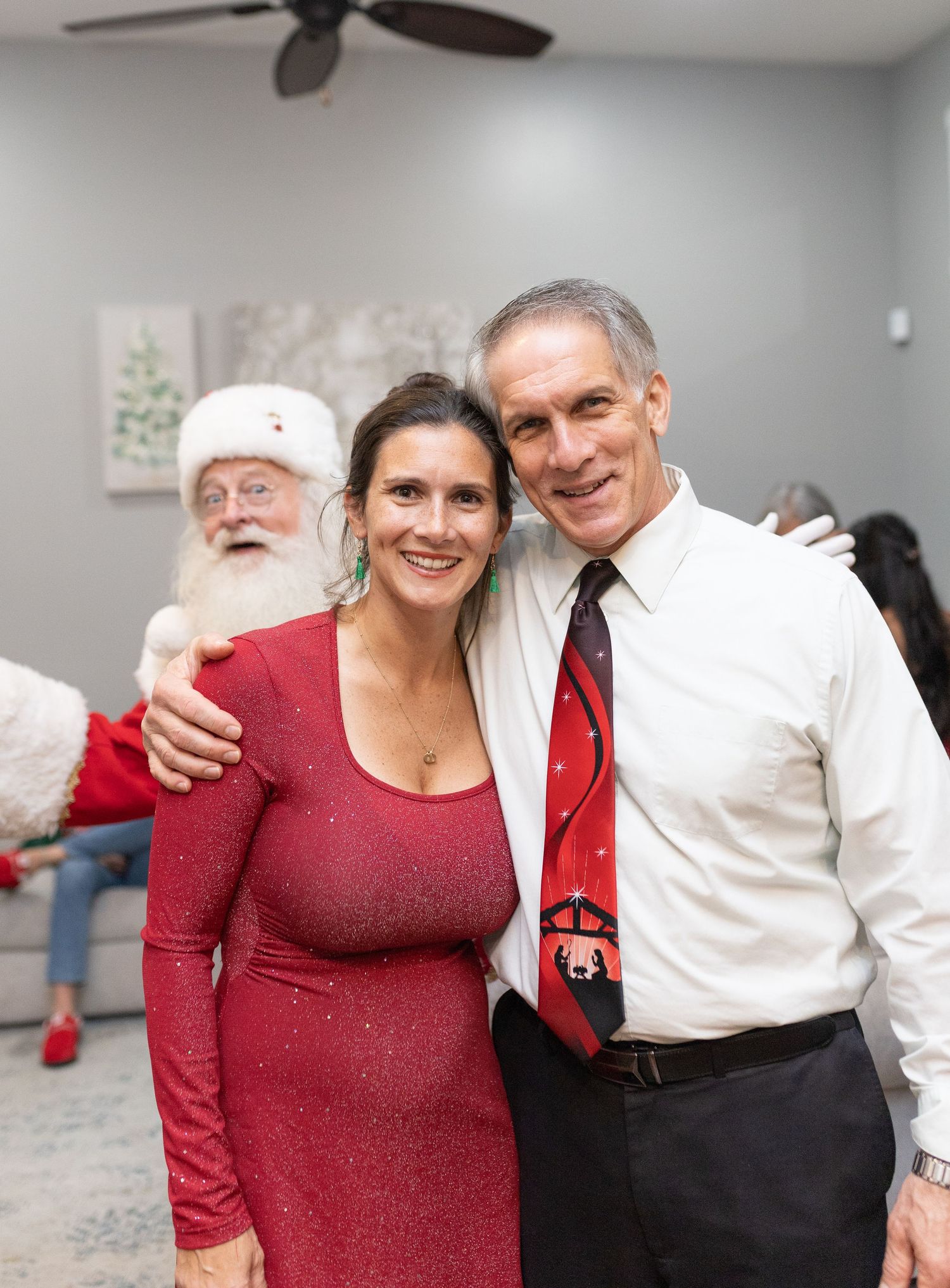 Group photo of people in holiday attire celebrating Christmas together.