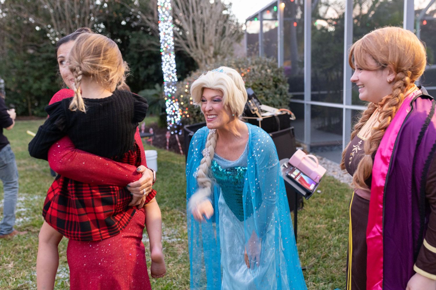 Group wearing colorful costumes dancing and celebrating outdoors.
