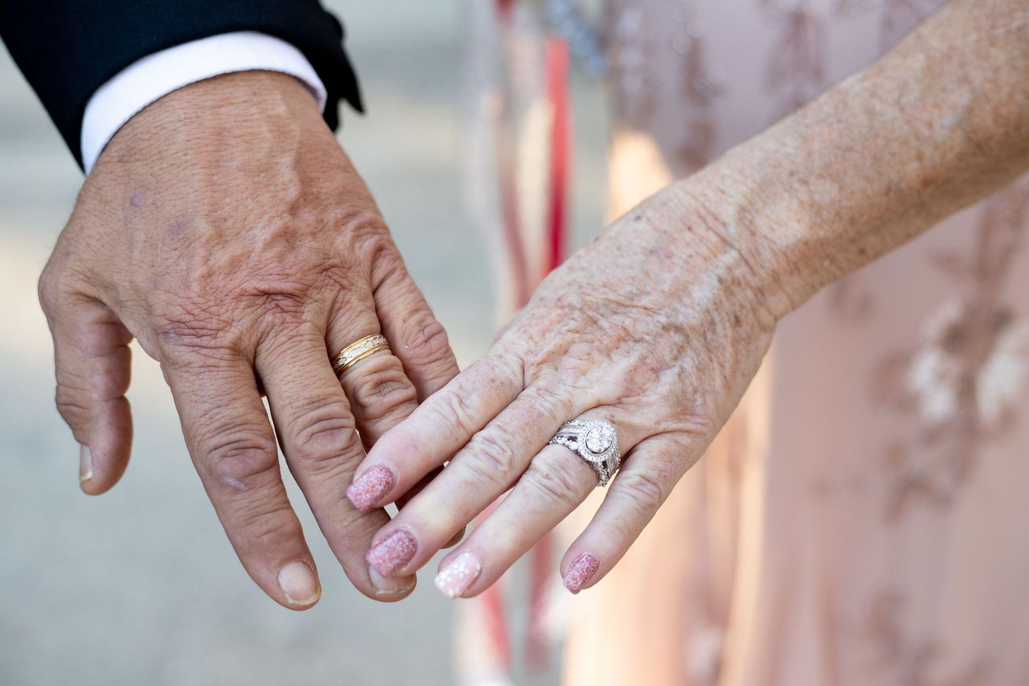 Close-up shots of wedding rings and hands during ceremony.