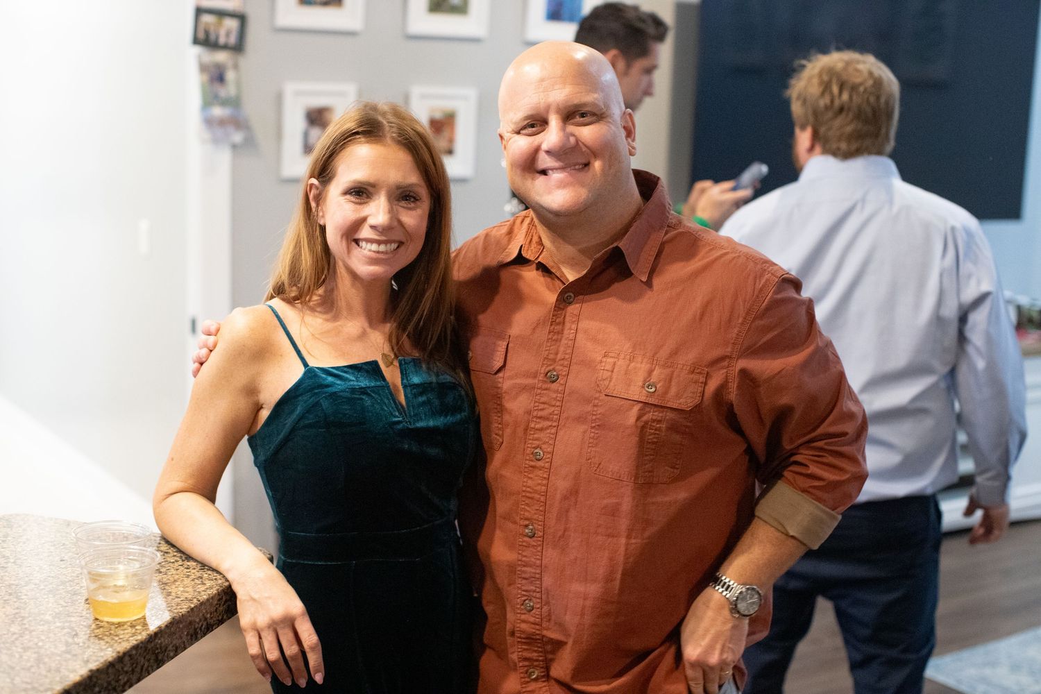 Friends enjoying conversation at a casual indoor social gathering.