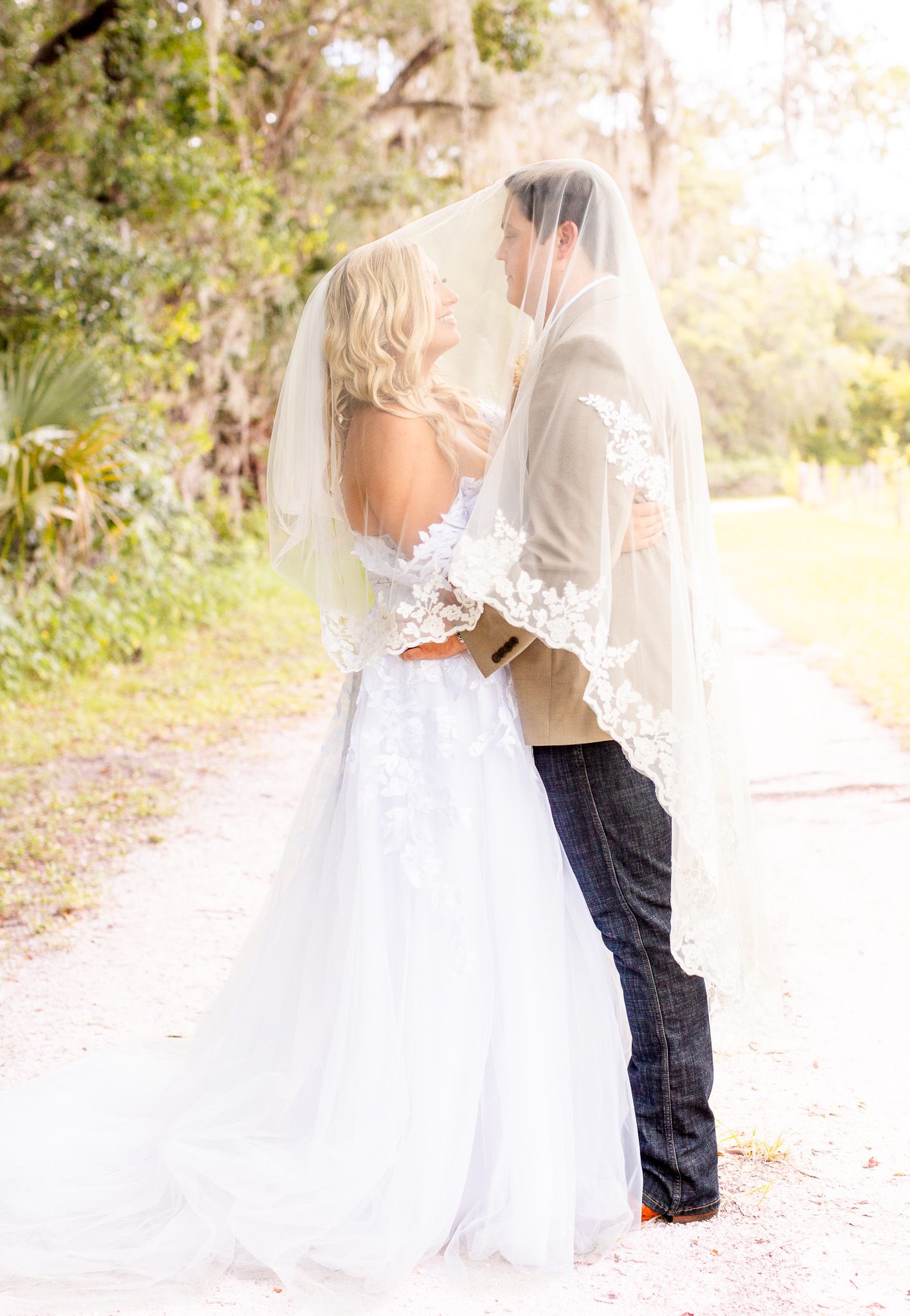 Ethereal wedding photographs with flowing veil and natural outdoor lighting creating romantic atmosphere.