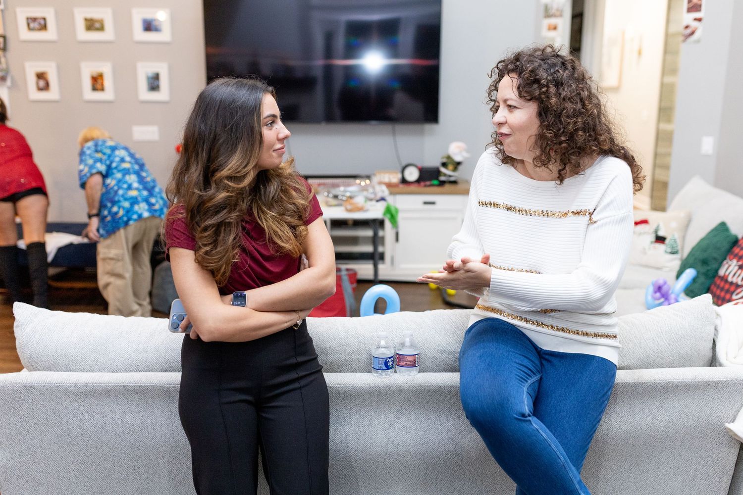 People relaxing on couches during a casual indoor gathering.