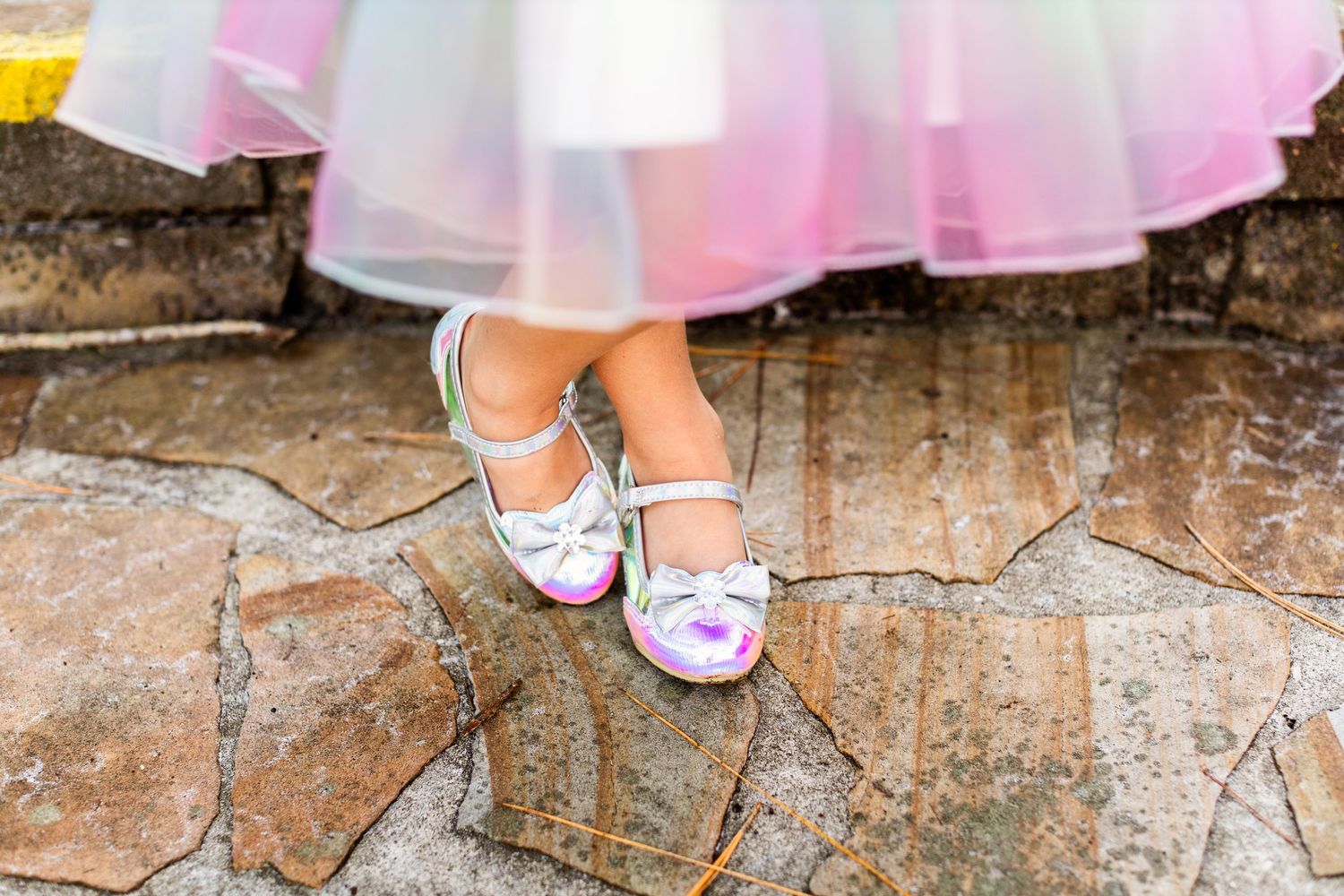Close-up shots of sparkly shoes and dress details on rustic stone steps.
