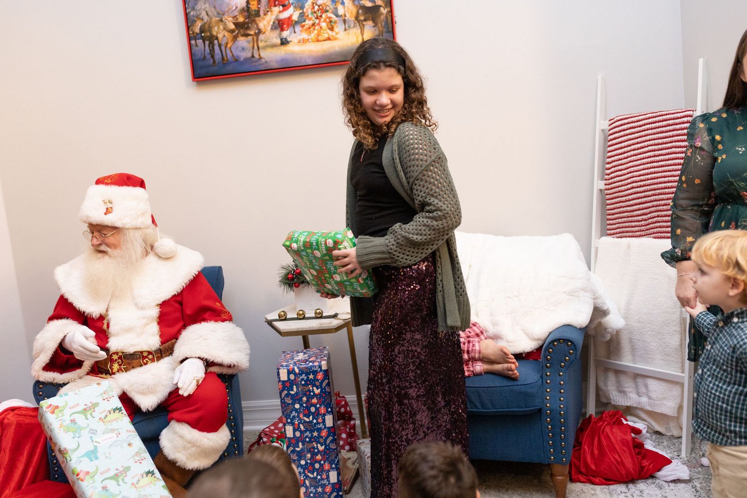 Holiday celebration with wrapped presents and festive decorations in a bright room.