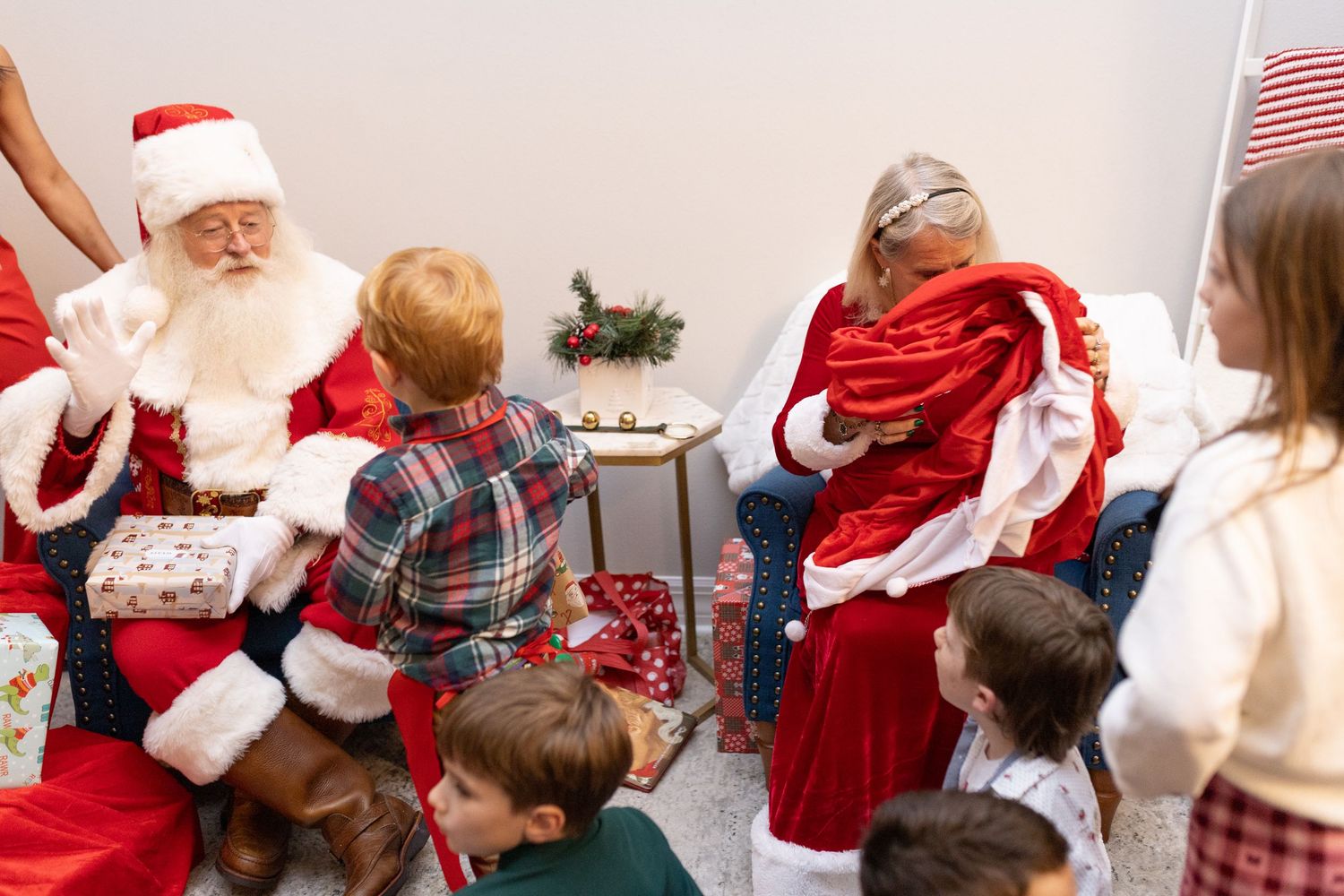 Holiday party scene with festive decorations and people gathered in a bright indoor space.