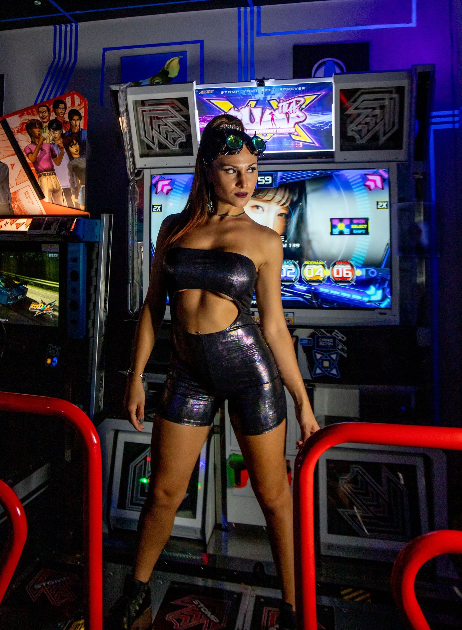 Retro arcade photoshoot with neon lights and metallic outfit.