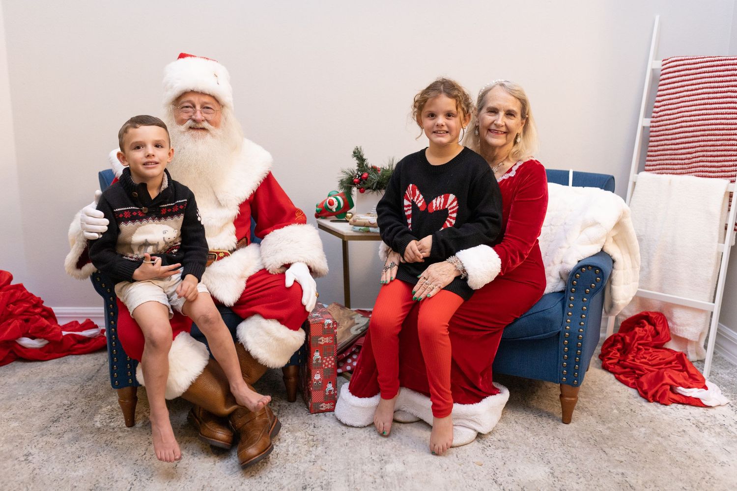 A holiday photo session with Santa Claus and guests wearing festive Christmas attire.