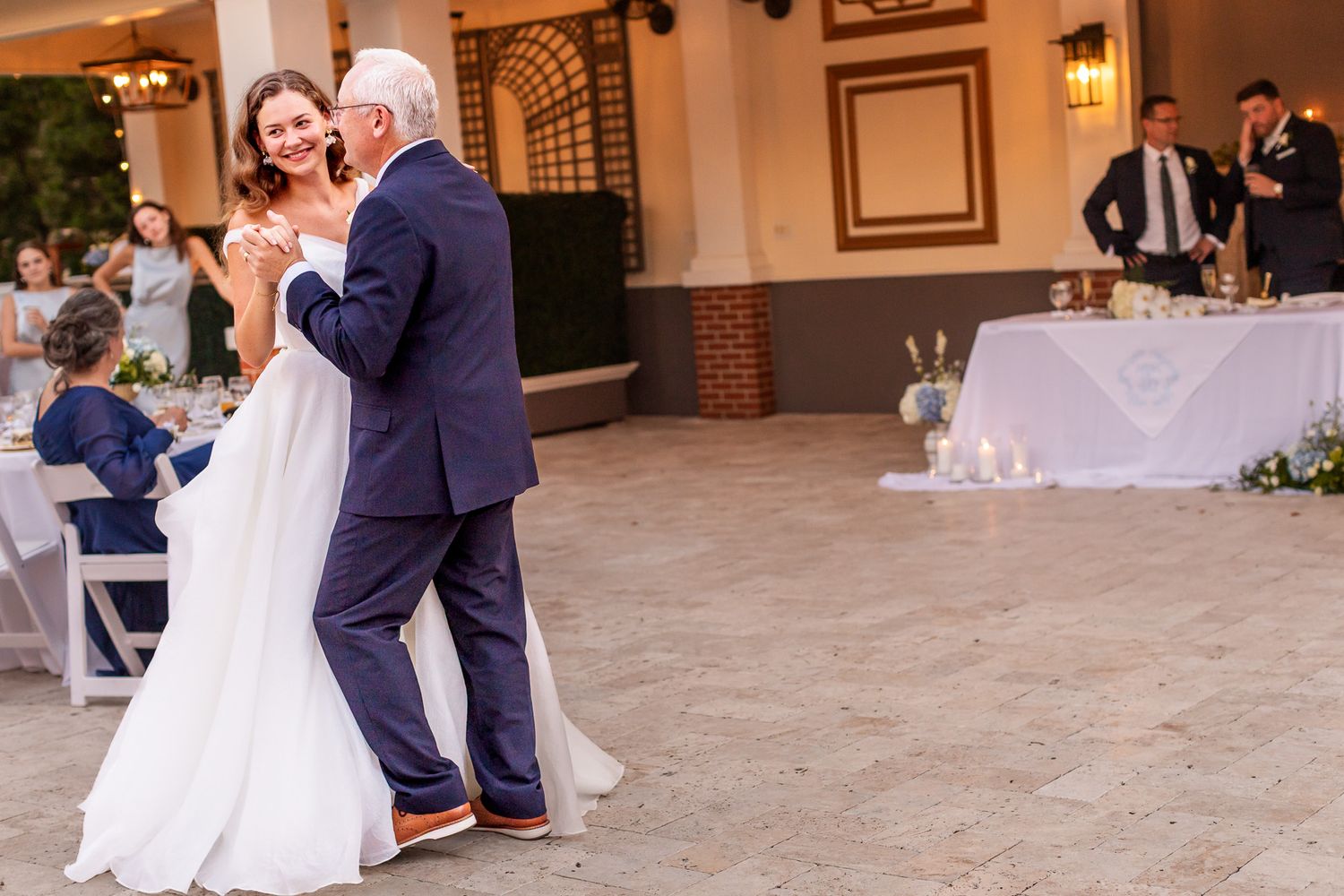 Bride and father share an emotional first dance at outdoor wedding reception venue.