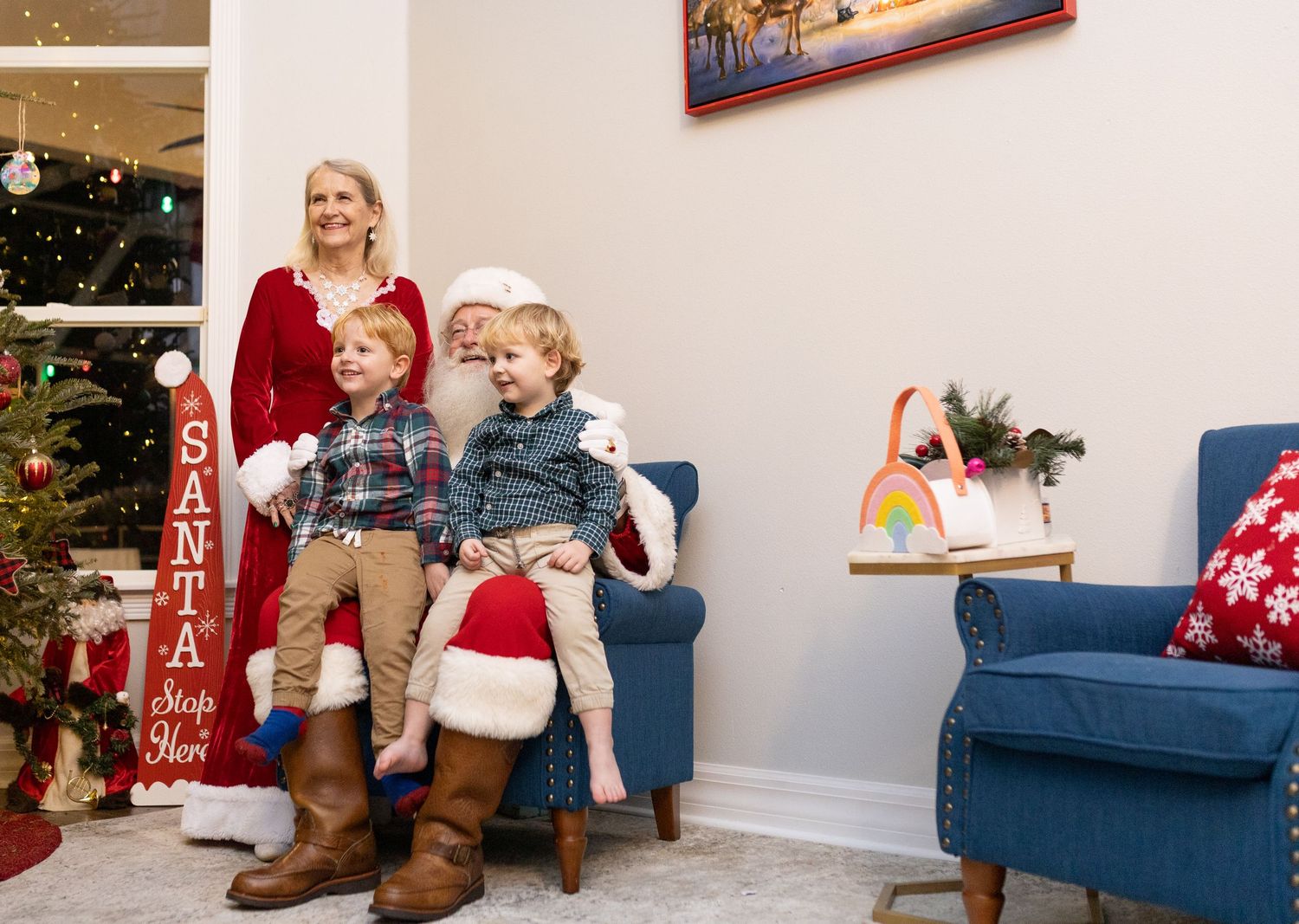 Festive holiday setting with Christmas decorations and a blue couch in a bright room.