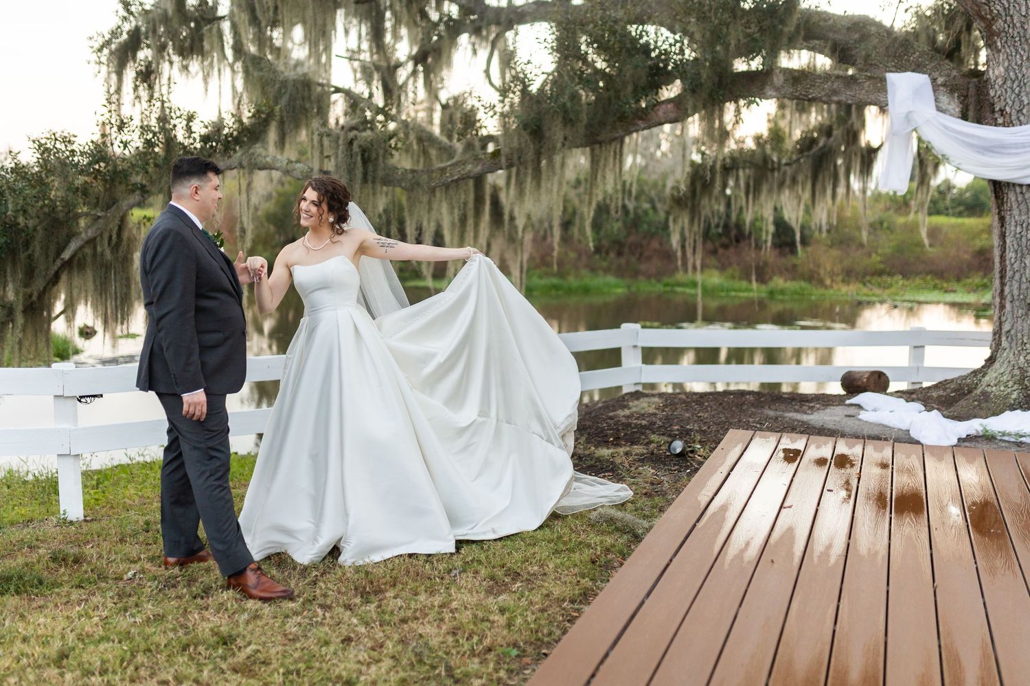 Wedding ceremony setup on a wooden dock overlooking a serene waterfront.