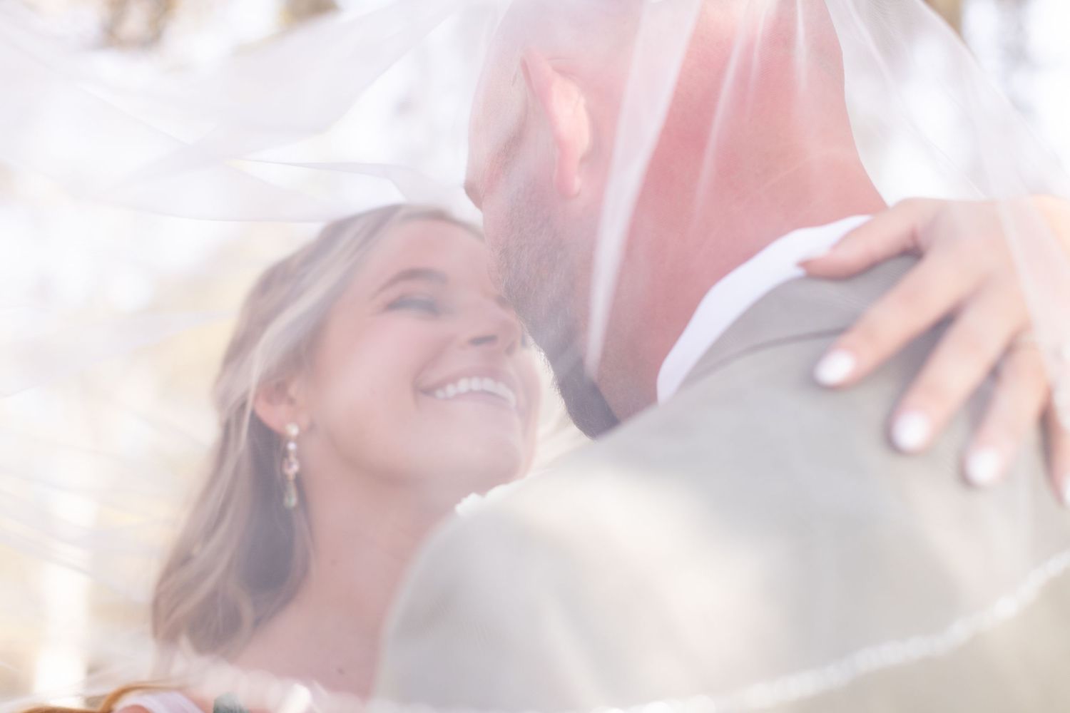 Soft romantic wedding portraits with delicate veil details.