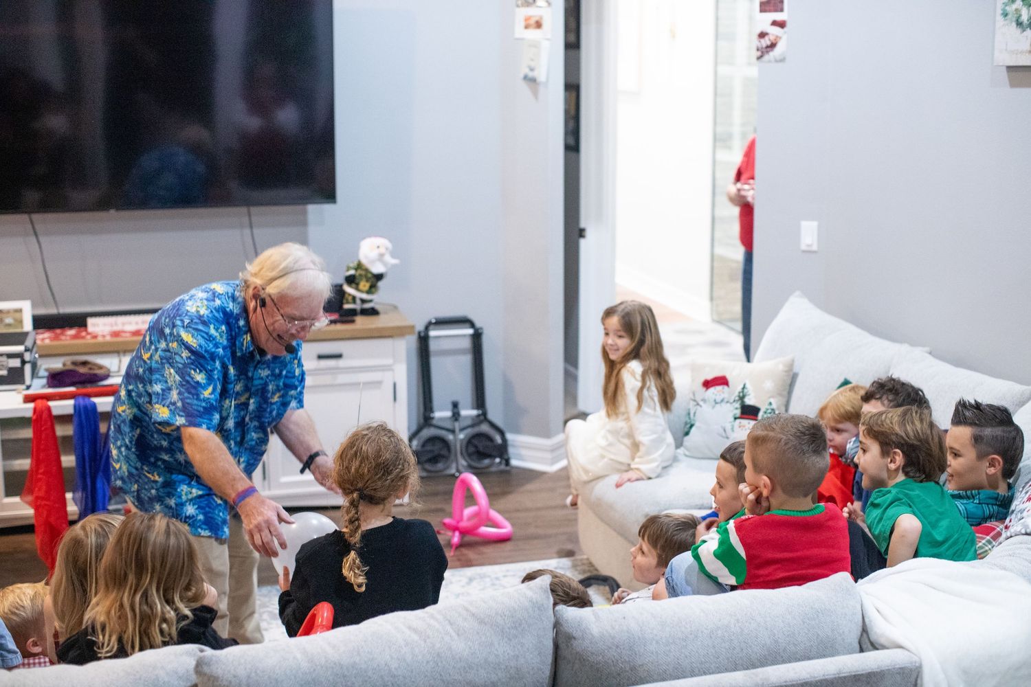 A casual indoor gathering with people sitting and socializing in a relaxed setting.