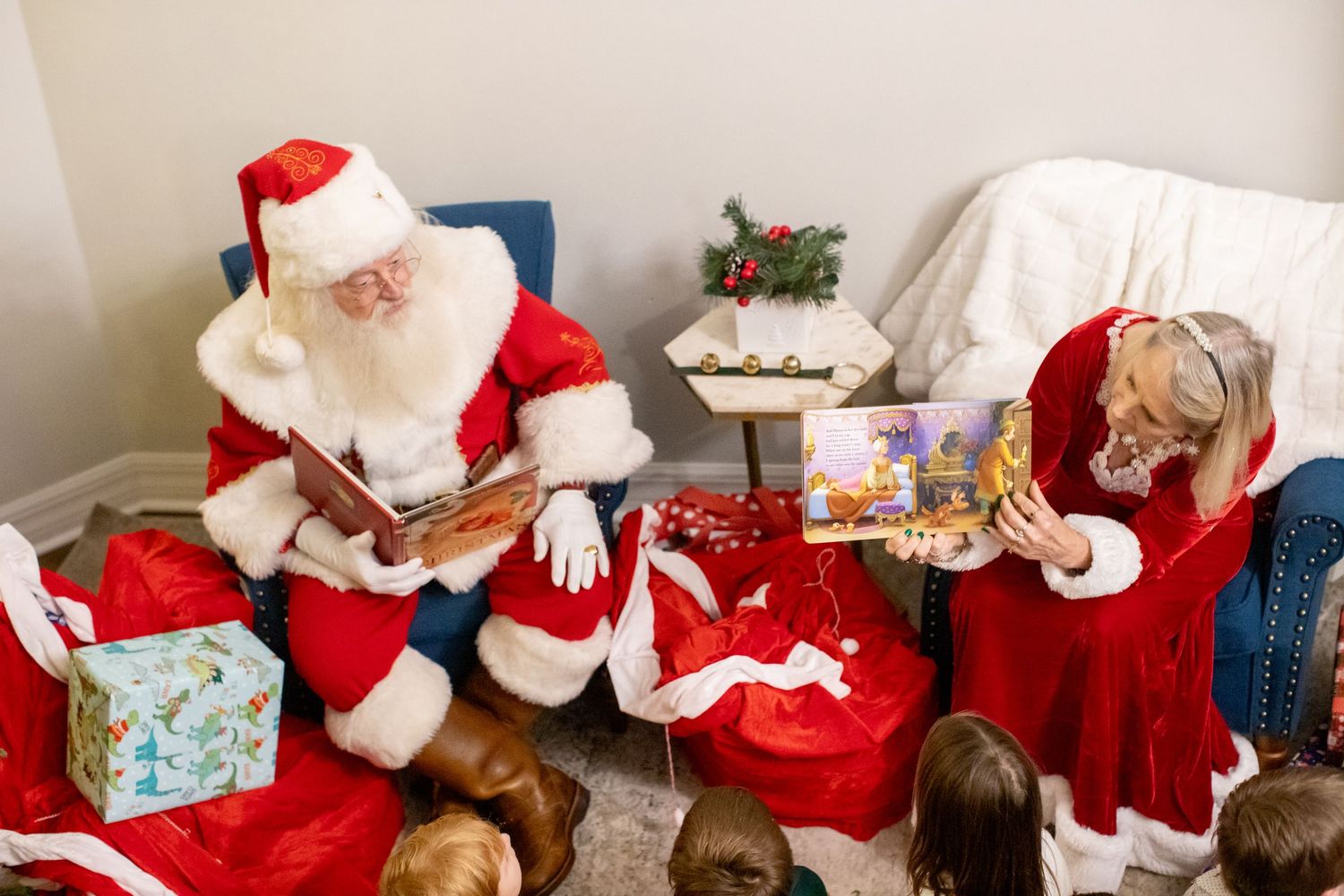 Santa Claus figures and holiday decorations arranged in a festive display.