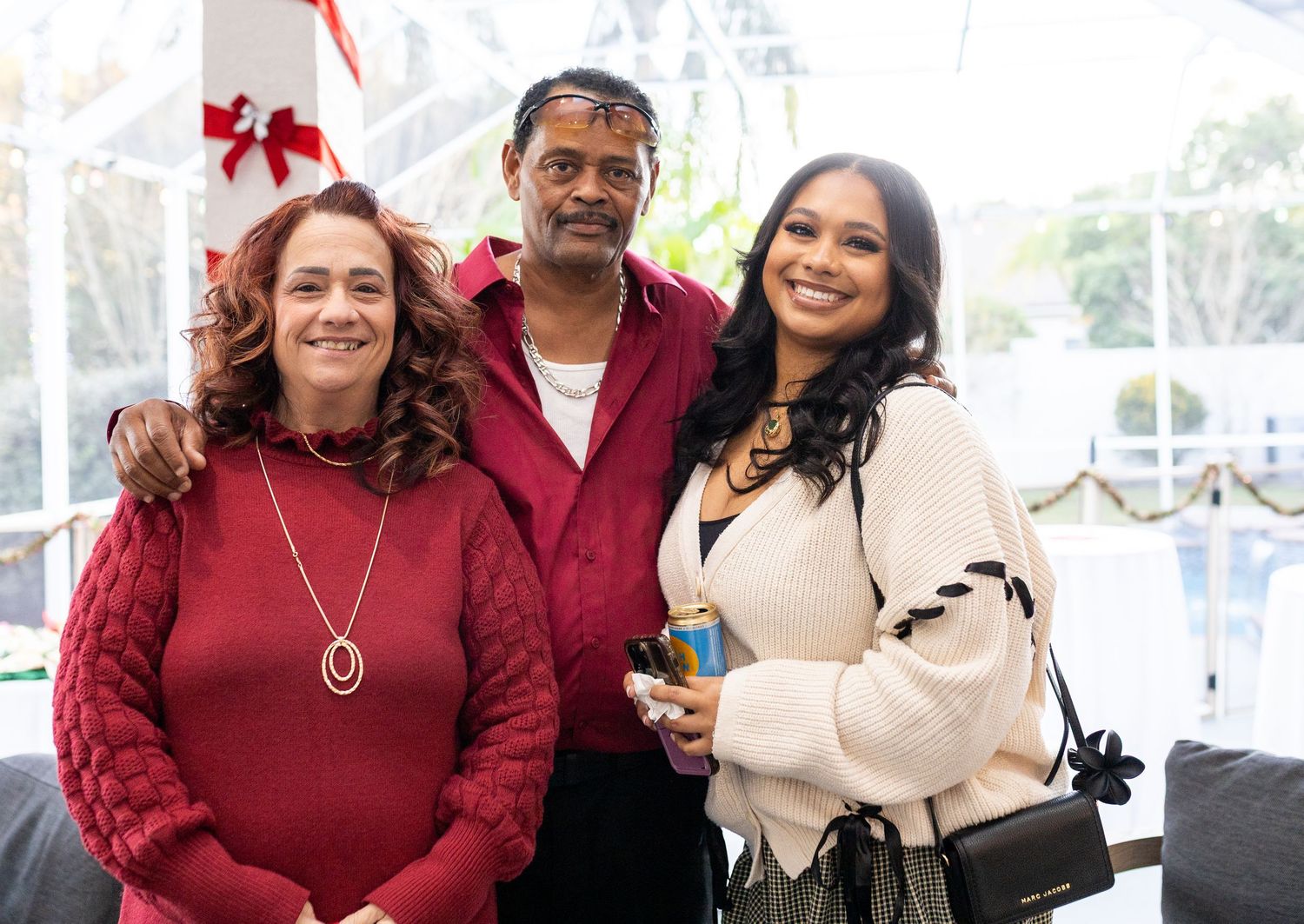 A group of people gathered at an outdoor holiday event wearing festive winter attire.