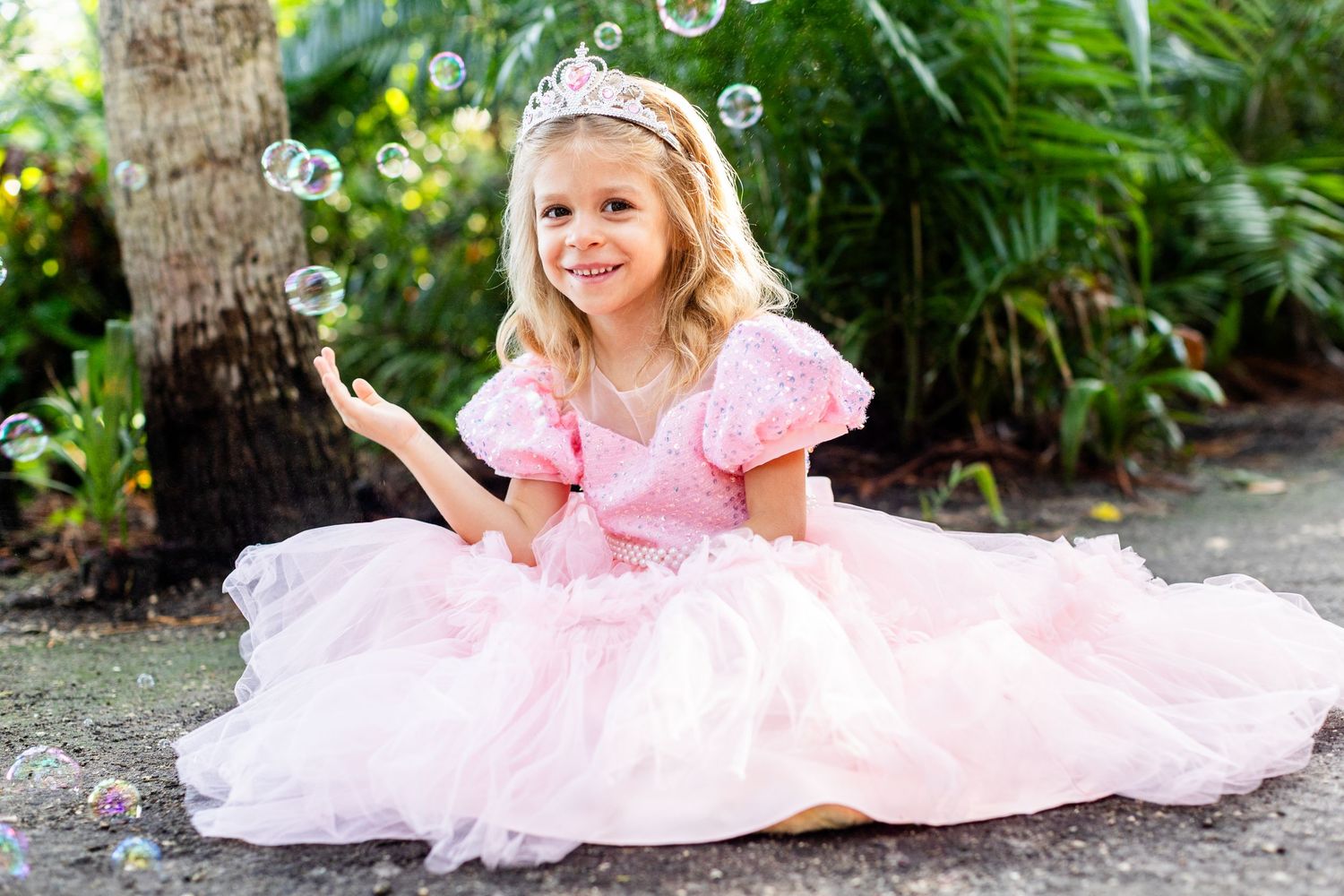 Enchanted garden scene with sparkling bubbles and a flowing pink princess gown.