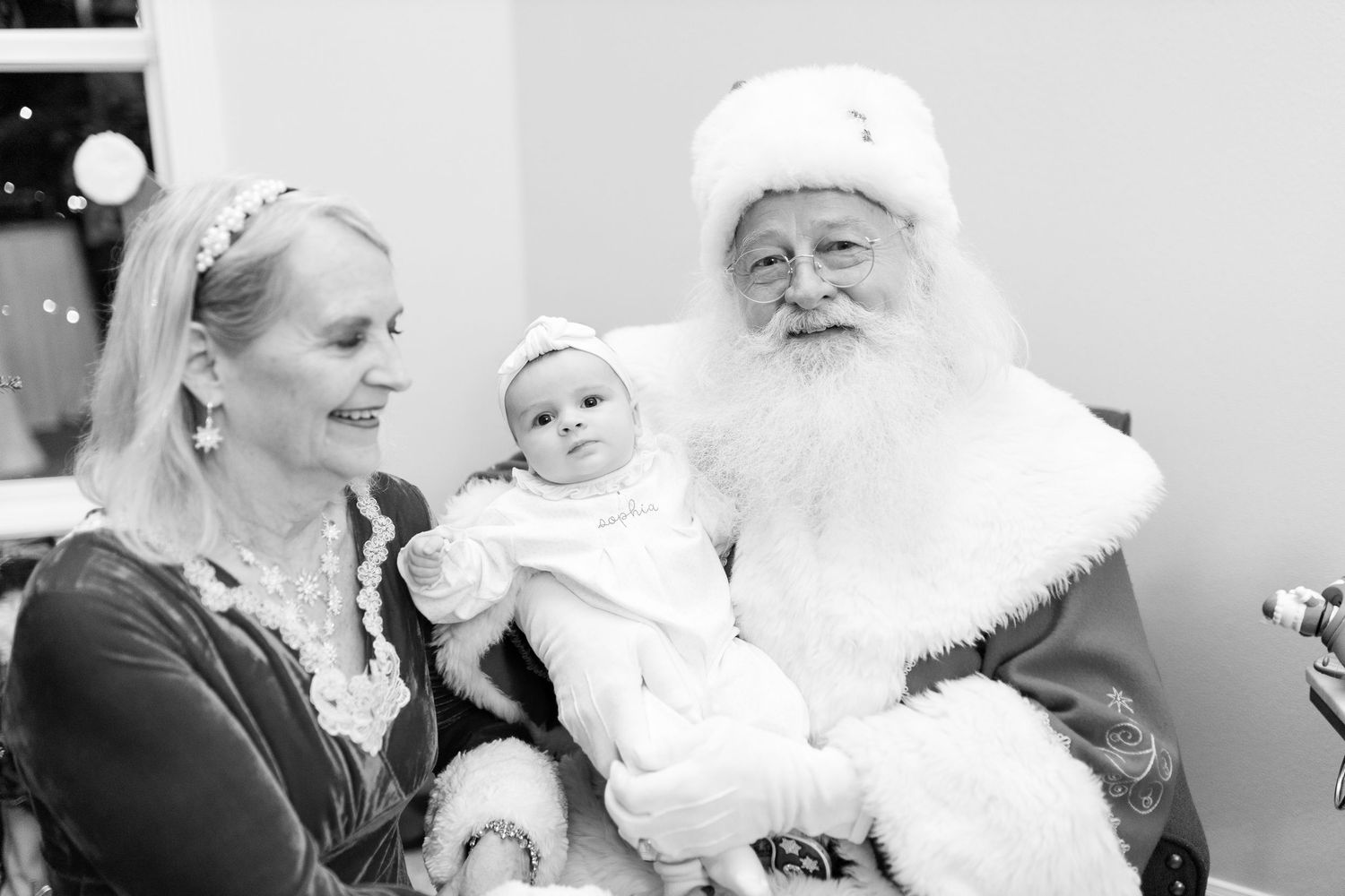 Black and white series capturing heartwarming Christmas photo session moments.