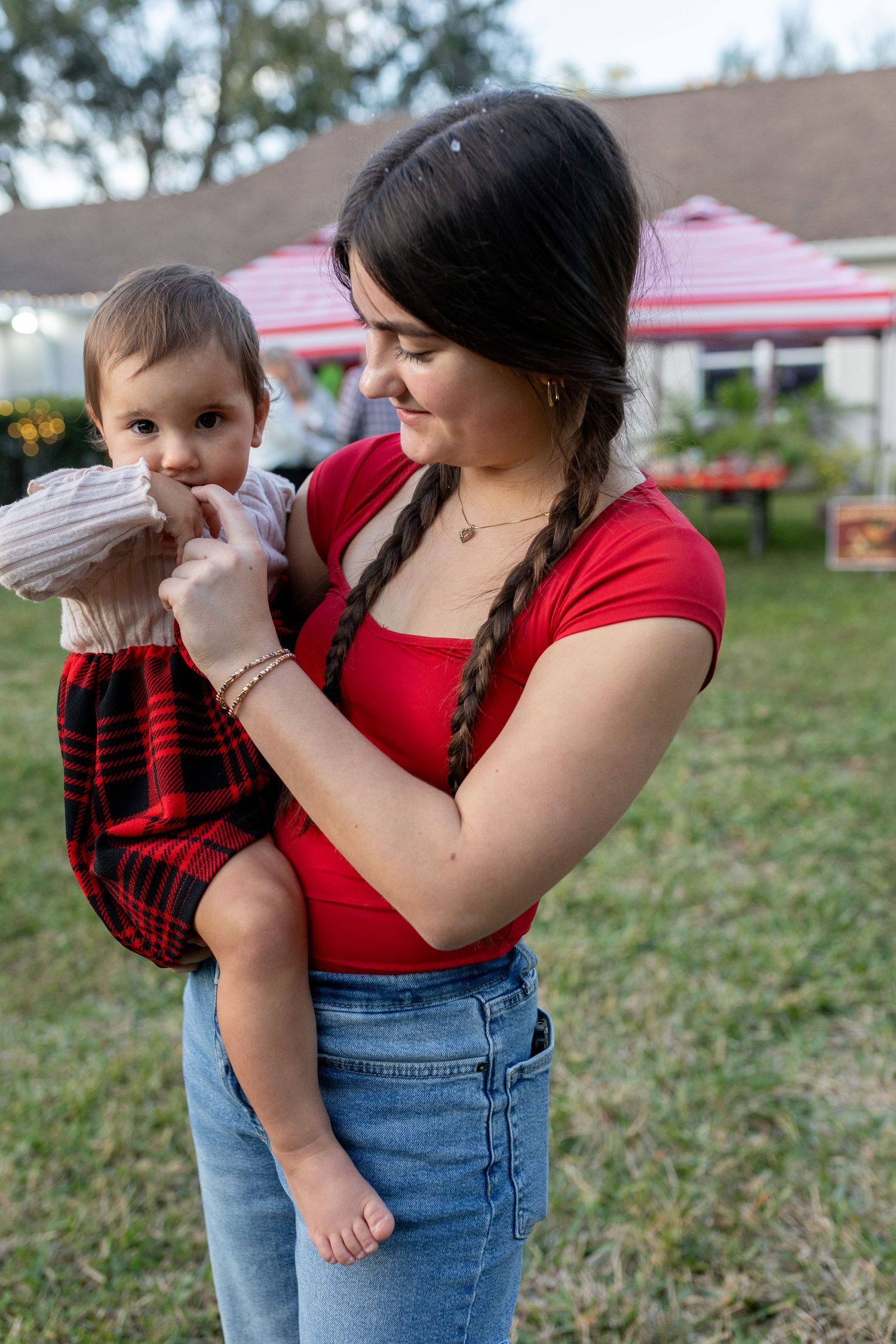 A tender moment captured outdoors during a casual family gathering.