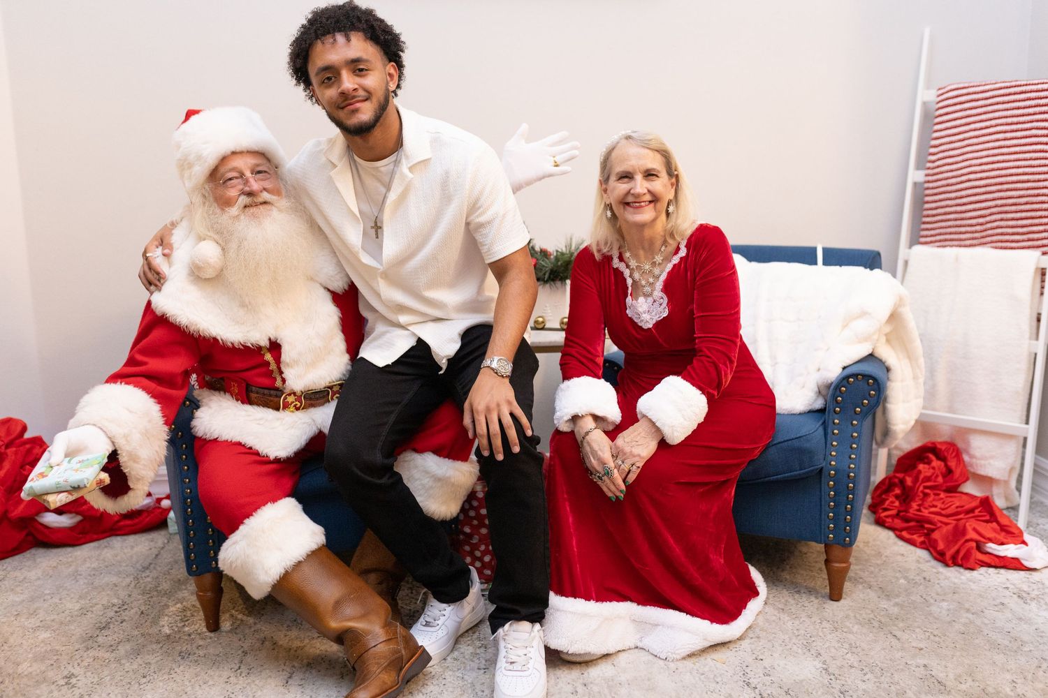 A joyful Christmas photo session with Santa Claus and guests in festive holiday attire.