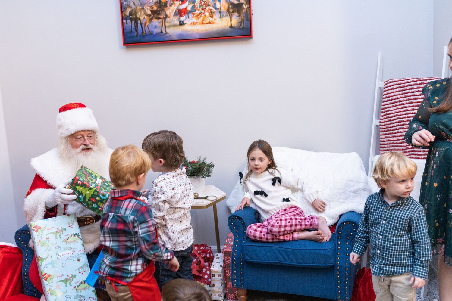 Christmas gathering in a room with wrapped presents and holiday decor.