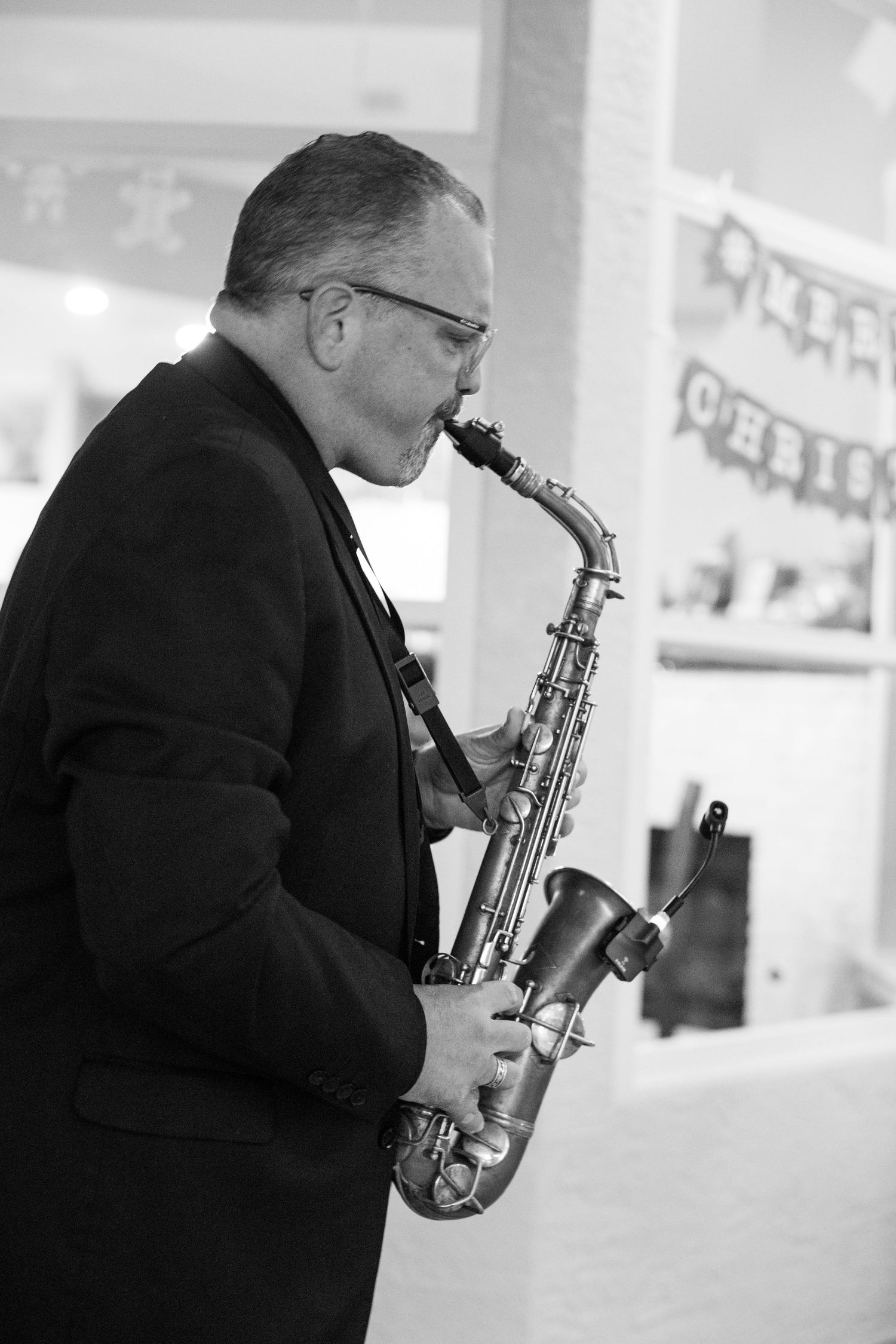 Musician playing saxophone in black and white photography sequence.