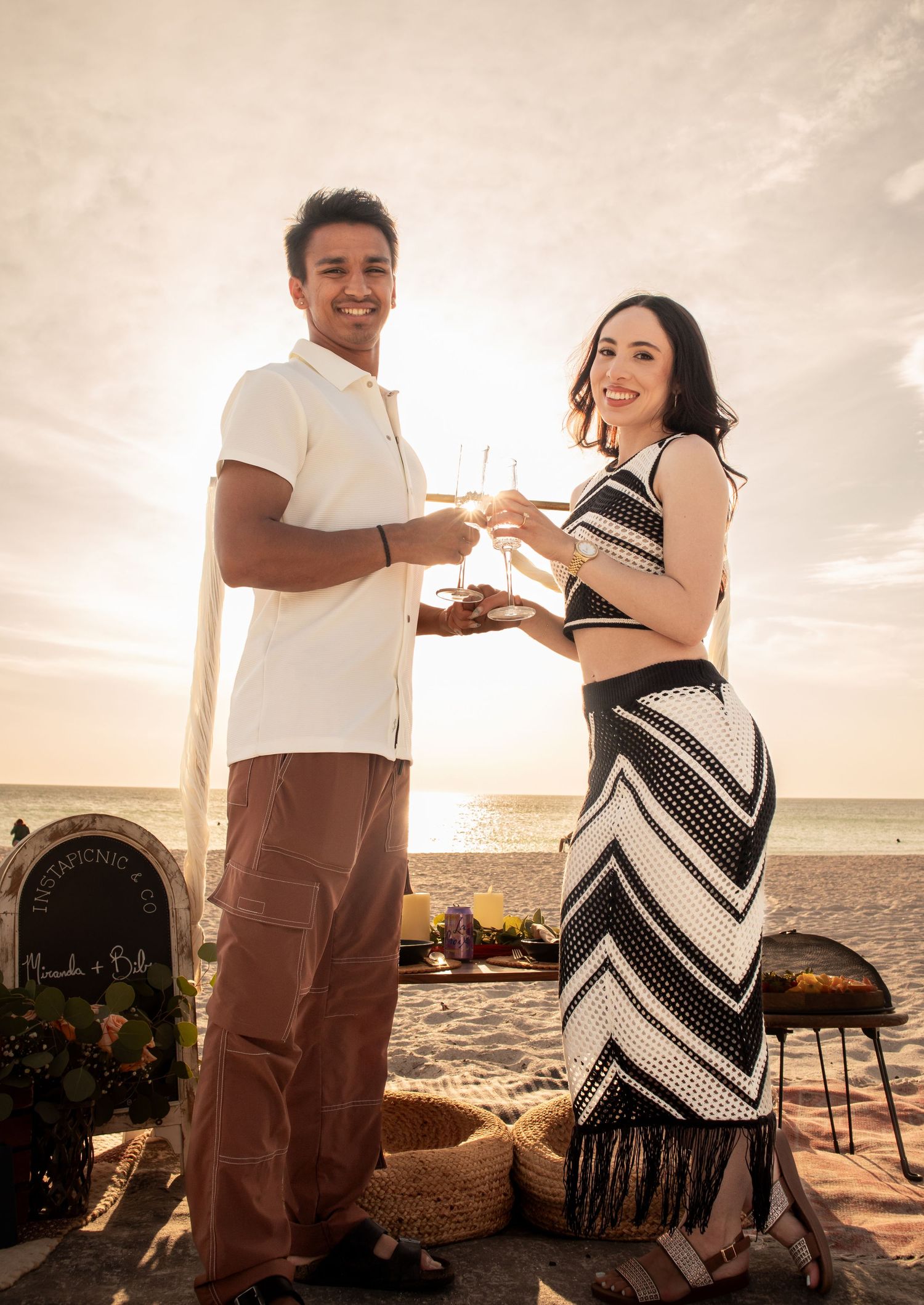 A sunset beach proposal with romantic decorations and ocean views.