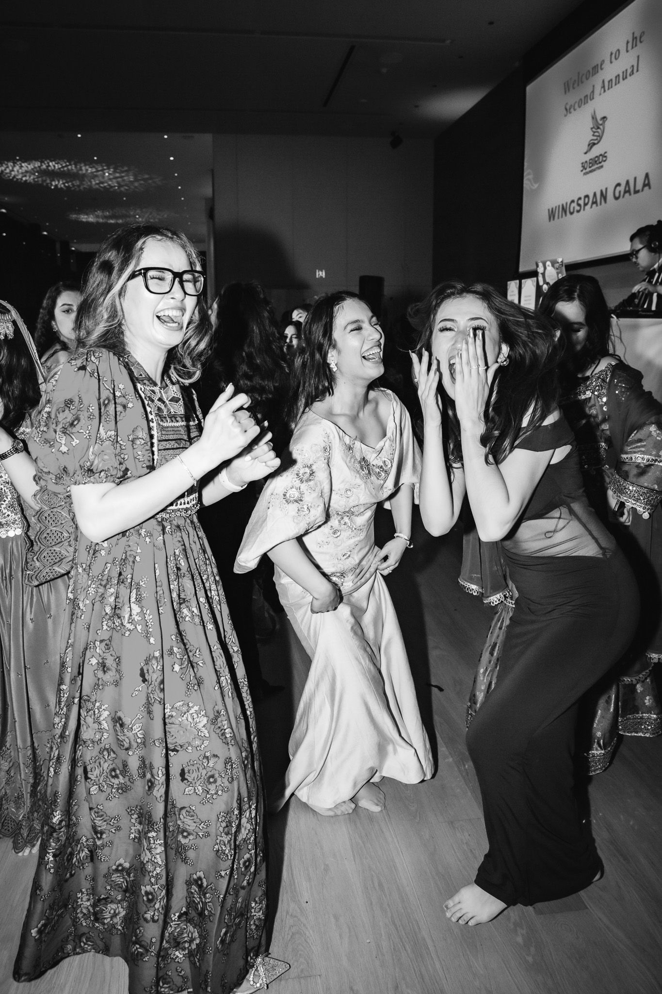Candid nonprofit gala photography capturing guests laughing during a leadership summit in Ottawa