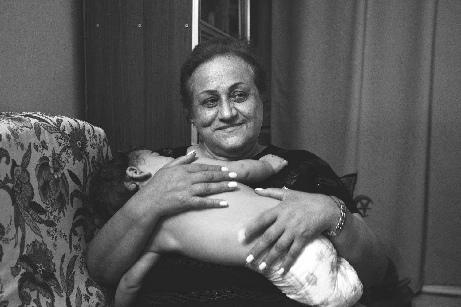Grandparent holding a baby during a documentary family photography session