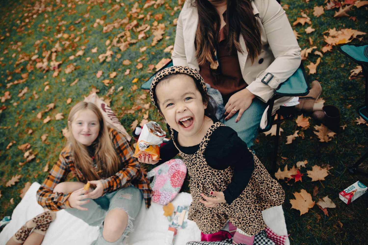 Children laughing outdoors during a fall family photography session in Ottawa