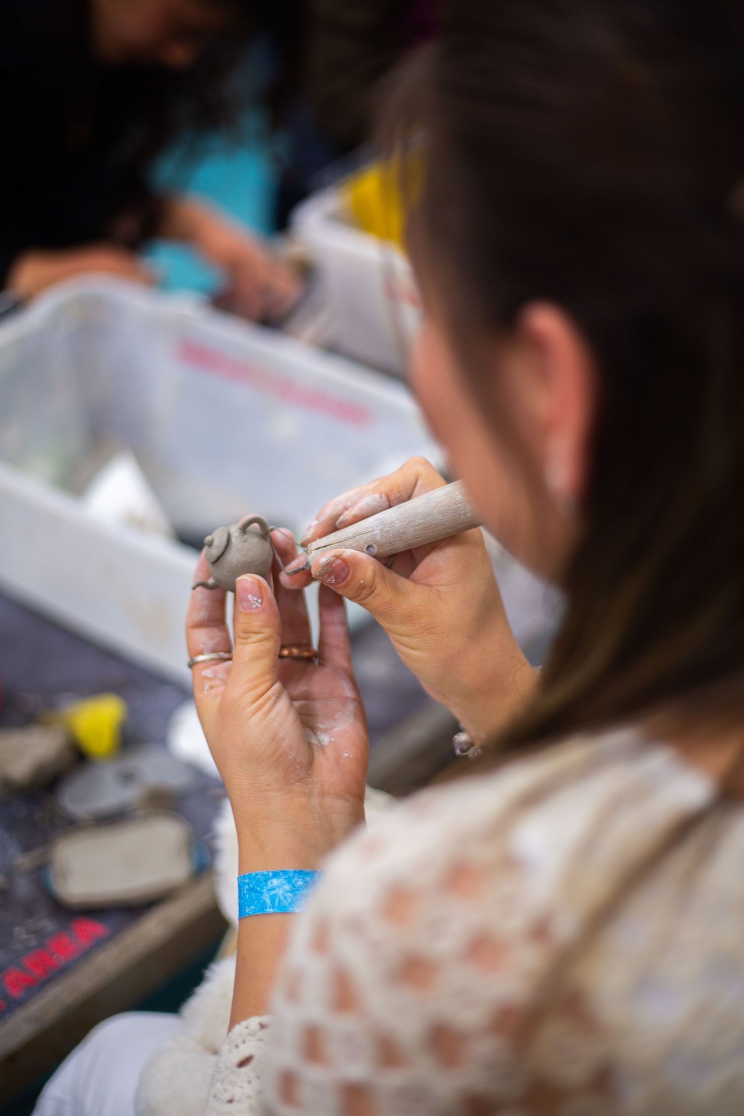 Hands shaping clay during a creative workshop photography session in Canada