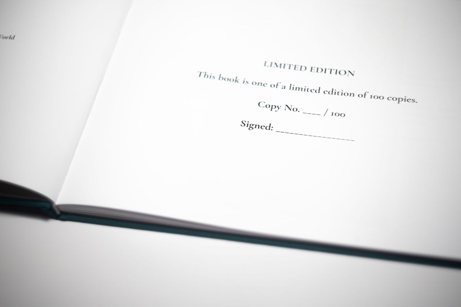 Open book showing a limited edition page with copy number and signature line, one of only 100 copies.