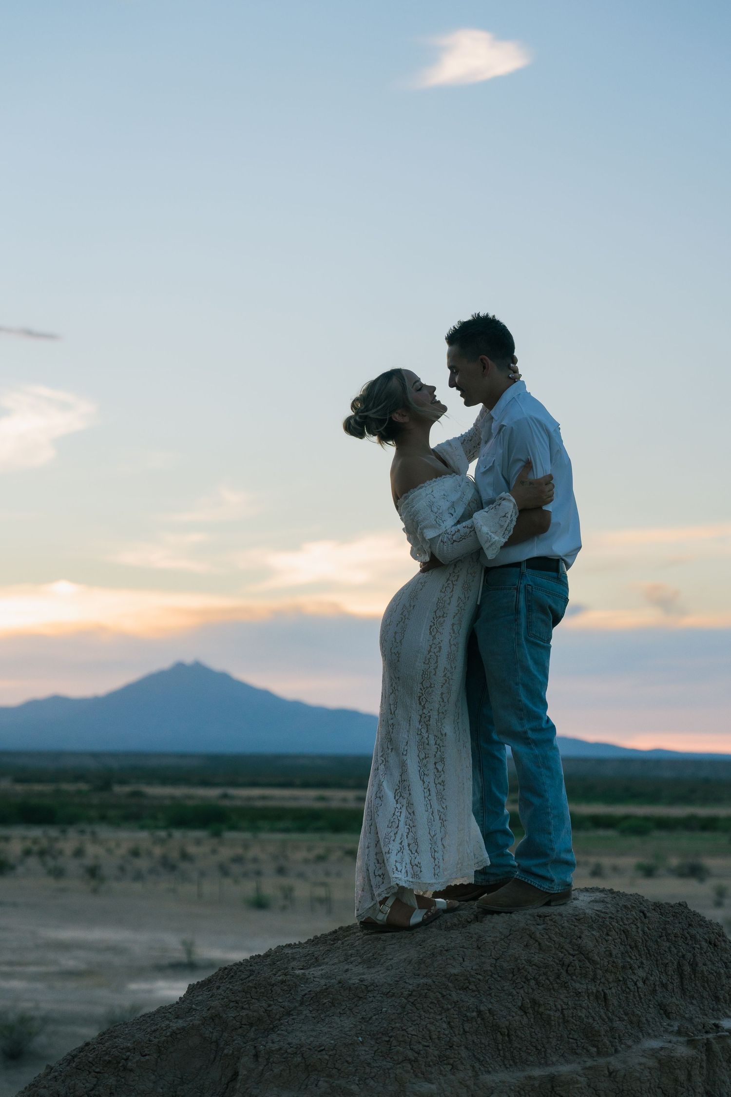 A couple posing in front of Mt Turnbull during an engagement shoot near Pima, Arizona.