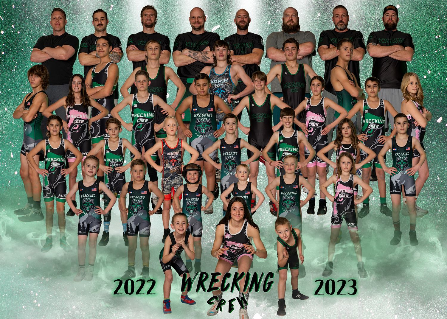 2022-2023 Wrecking Crew youth wrestling team group portrait with coaches on green sparkling background.