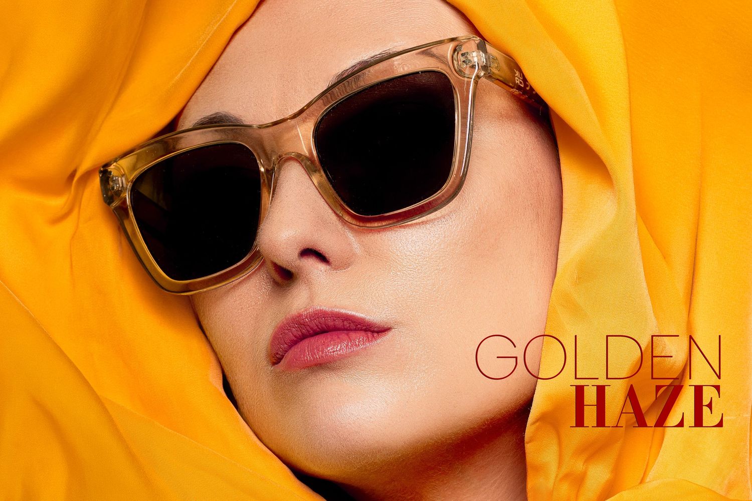 Woman in golden yellow hijab wearing Golden Haze square sunglasses with dark lenses, fashion eyewear advertisement.