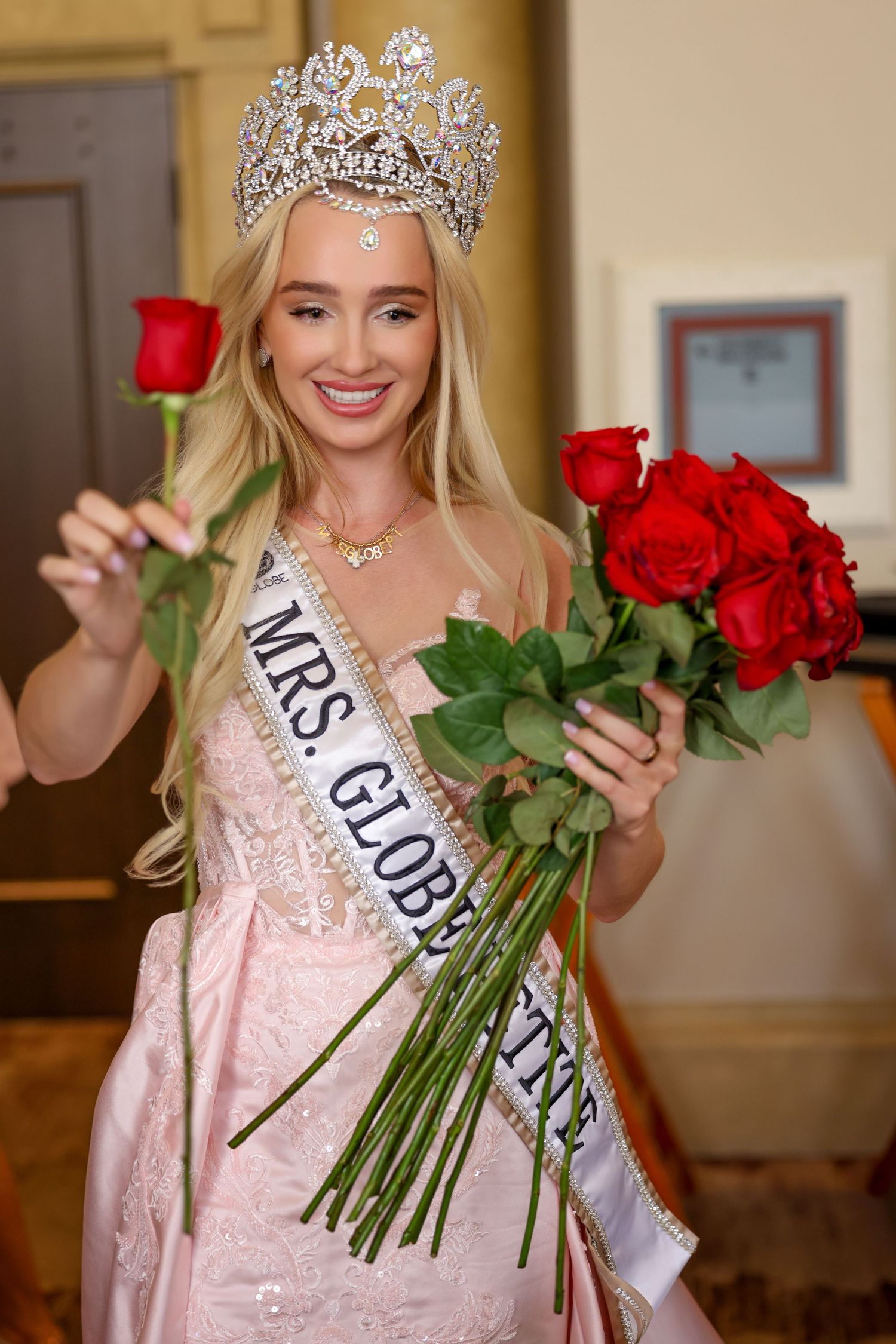 A blonde pageant queen wearing a large crystal crown and a 