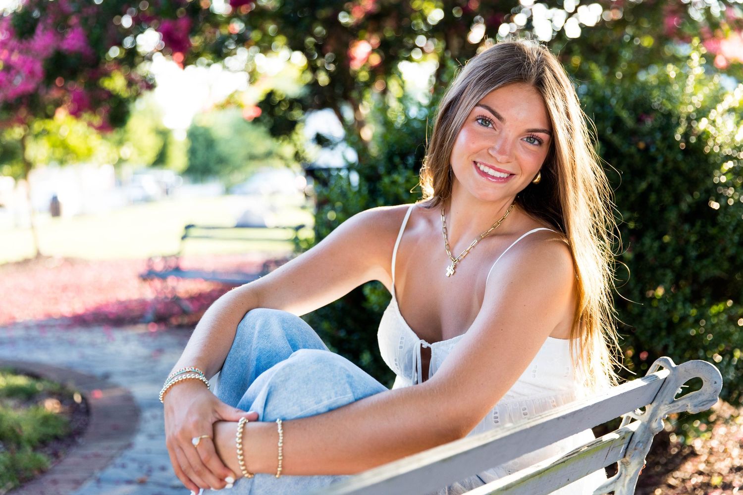 RVA Richmond Virginia senior photographer. Young woman sitting on a park bench in Ashland, Virginia.