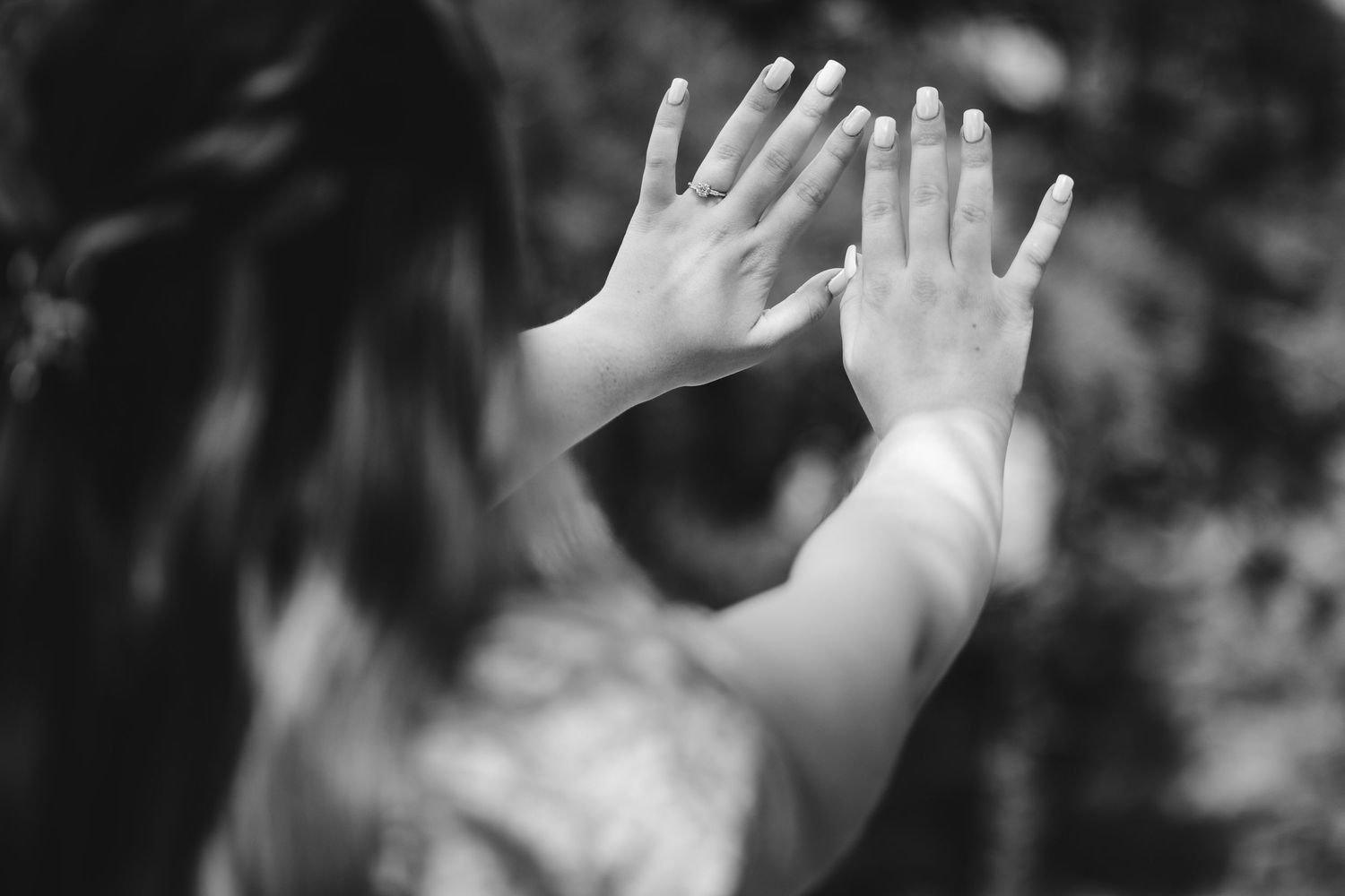 Multiple hands raised against a dark background in a sequence showing gradual motion.
