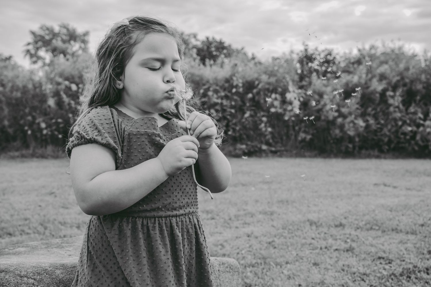 Black and white portrait series showing candid moments in a field.
